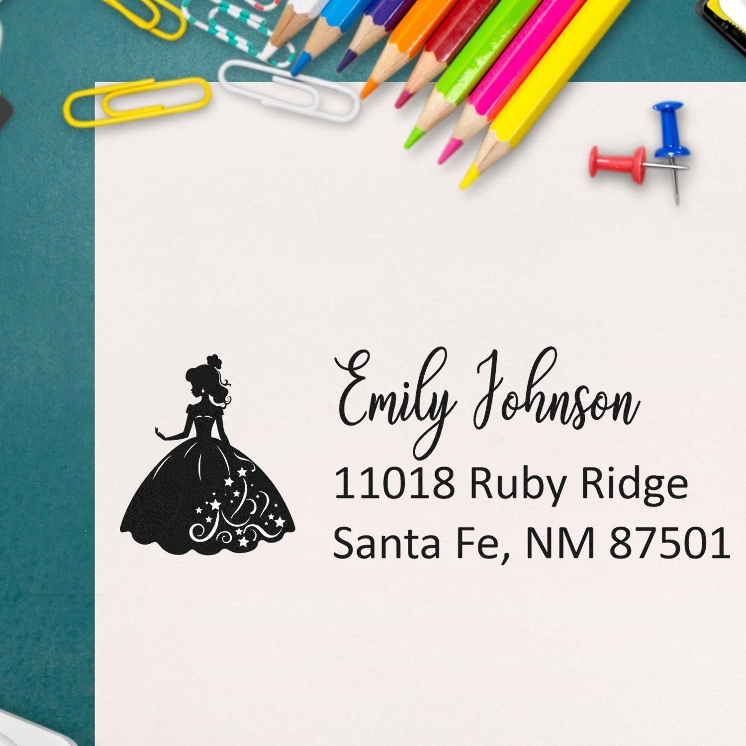 Custom address rubber stamp with princess silhouette for Emily Johnson, 11018 Ruby Ridge, Santa Fe, NM 87501.