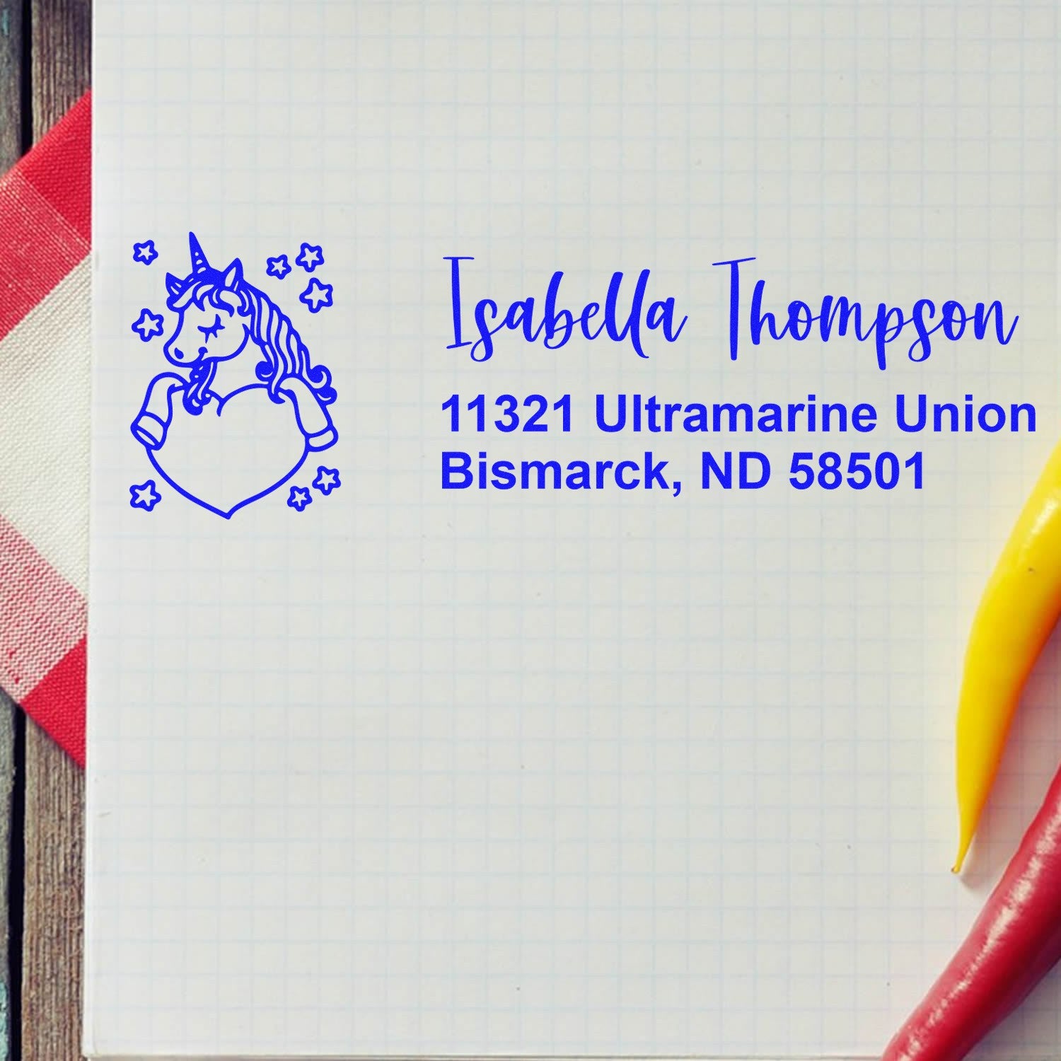 Personalized unicorn return address rubber stamp with Isabella Thompson name and Bismarck, ND mailing address in blue ink