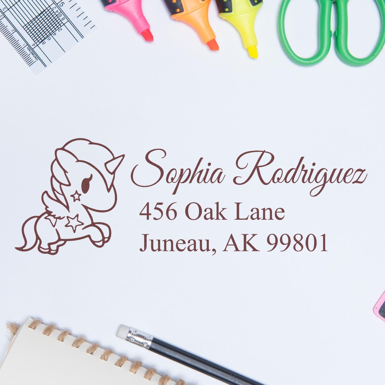 Custom rubber stamp proof with unicorn return address design for Sophia Rodriguez, Juneau, AK 99801.