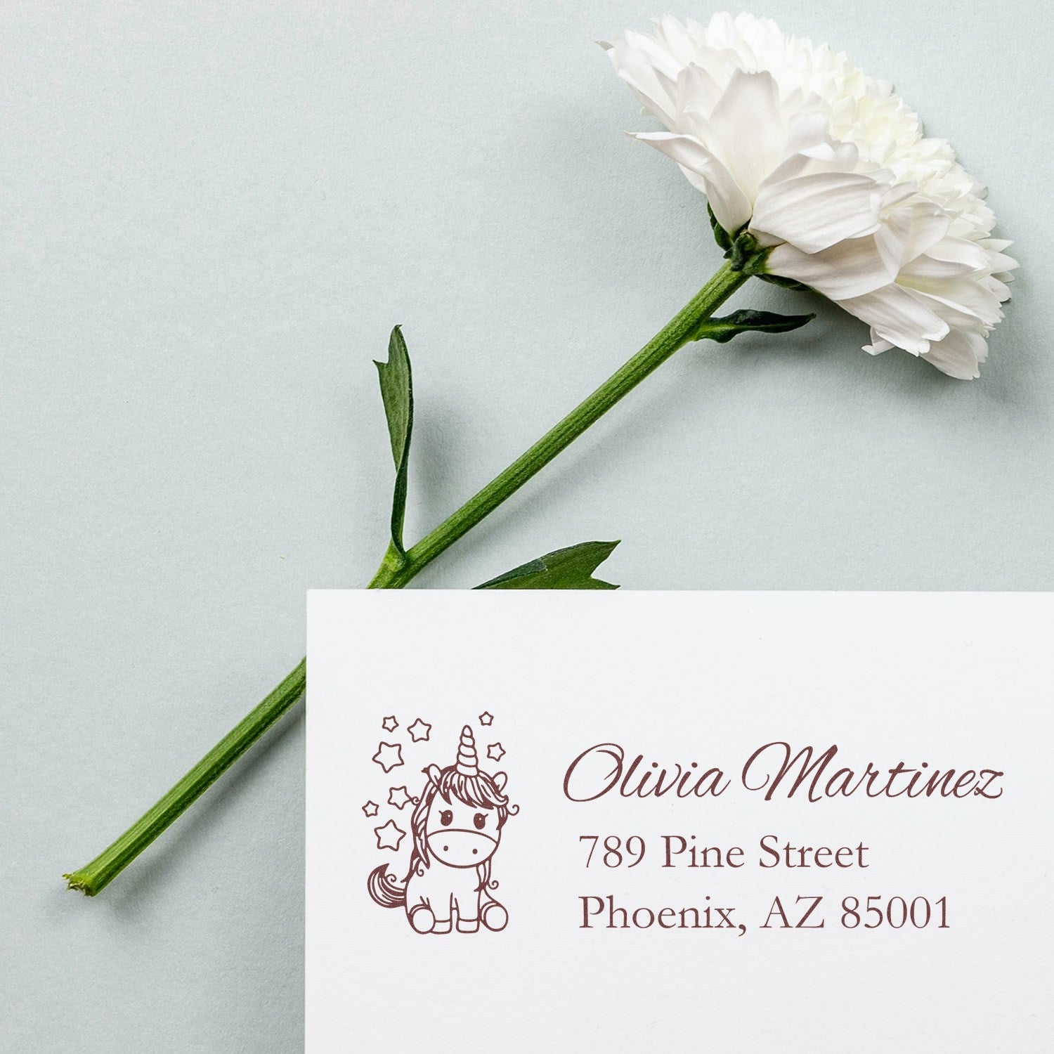 Custom unicorn return address rubber stamp with name and Phoenix address on a white card, ideal for invitations.
