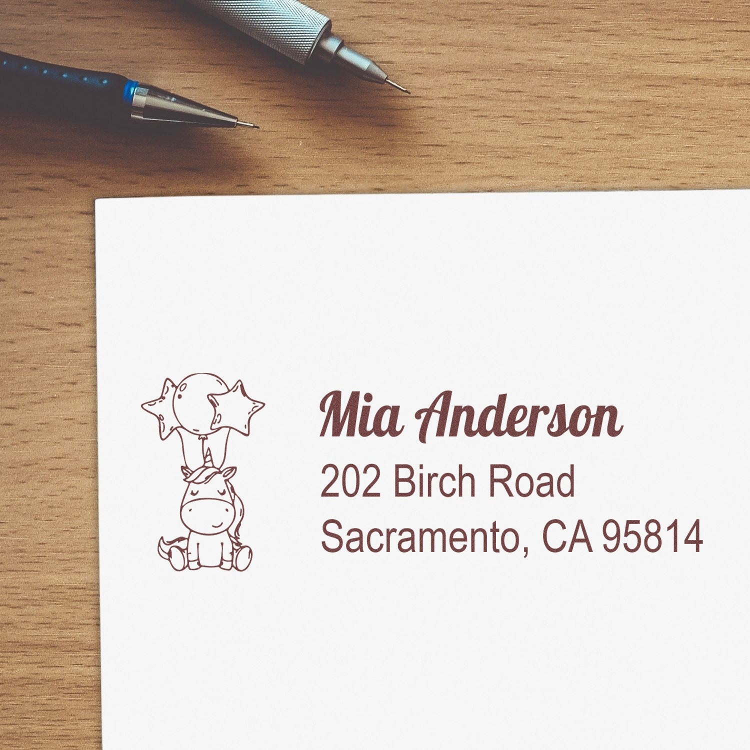 Personalized return address rubber stamp with unicorn and balloon design for Mia Anderson, Sacramento, CA 95814.
