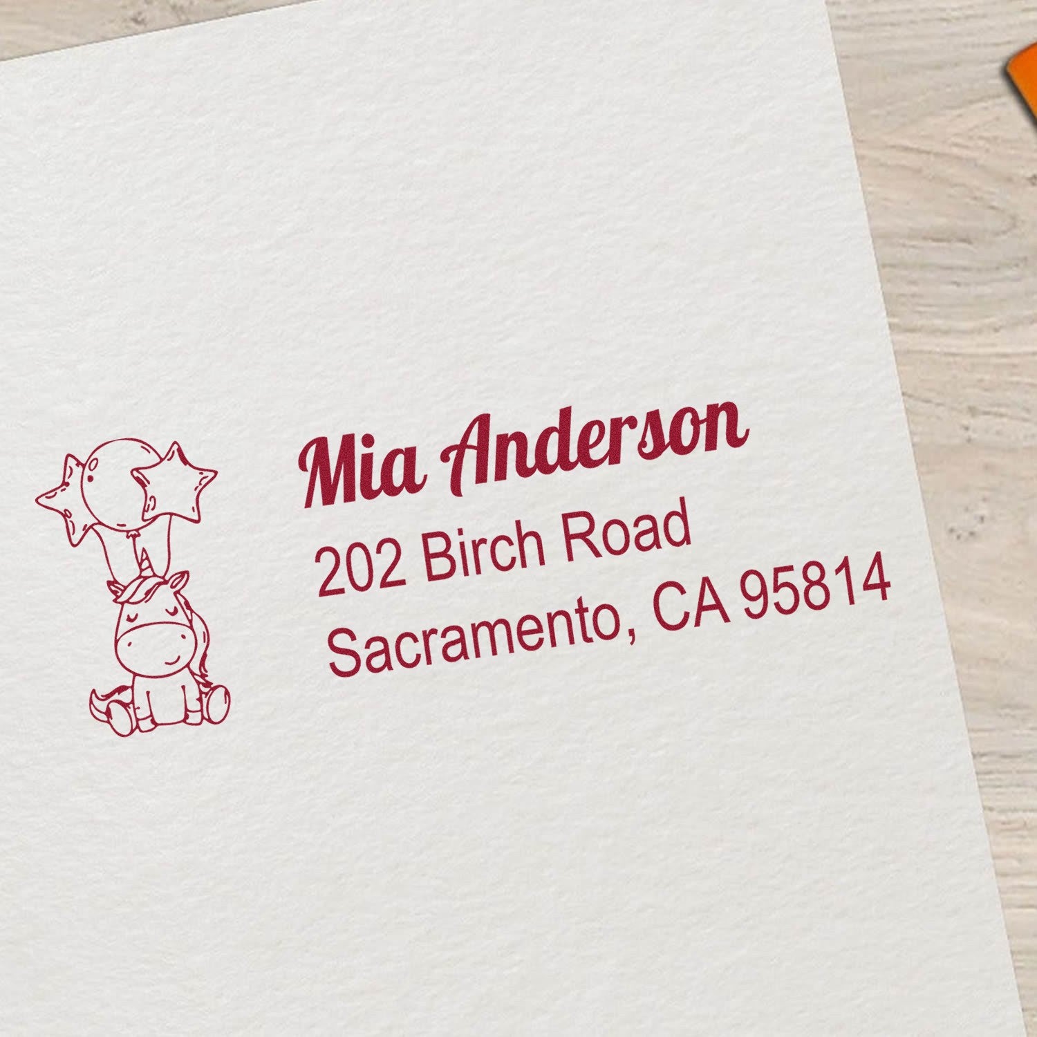 Custom rubber stamp with unicorn design and return address for Mia Anderson, 202 Birch Road, Sacramento, CA 95814.