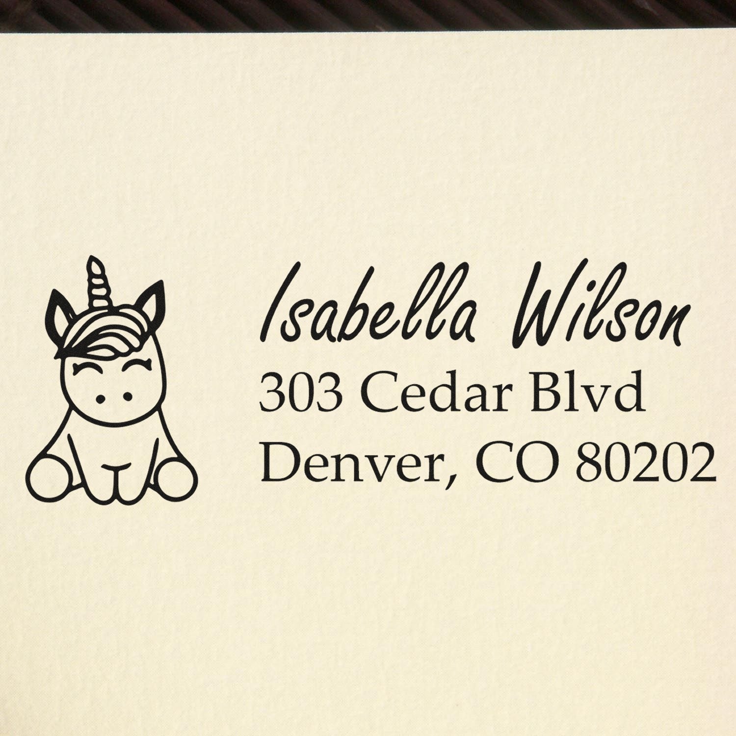 Personalized unicorn rubber address stamp with name Isabella Wilson and Denver, CO 80202 return address.