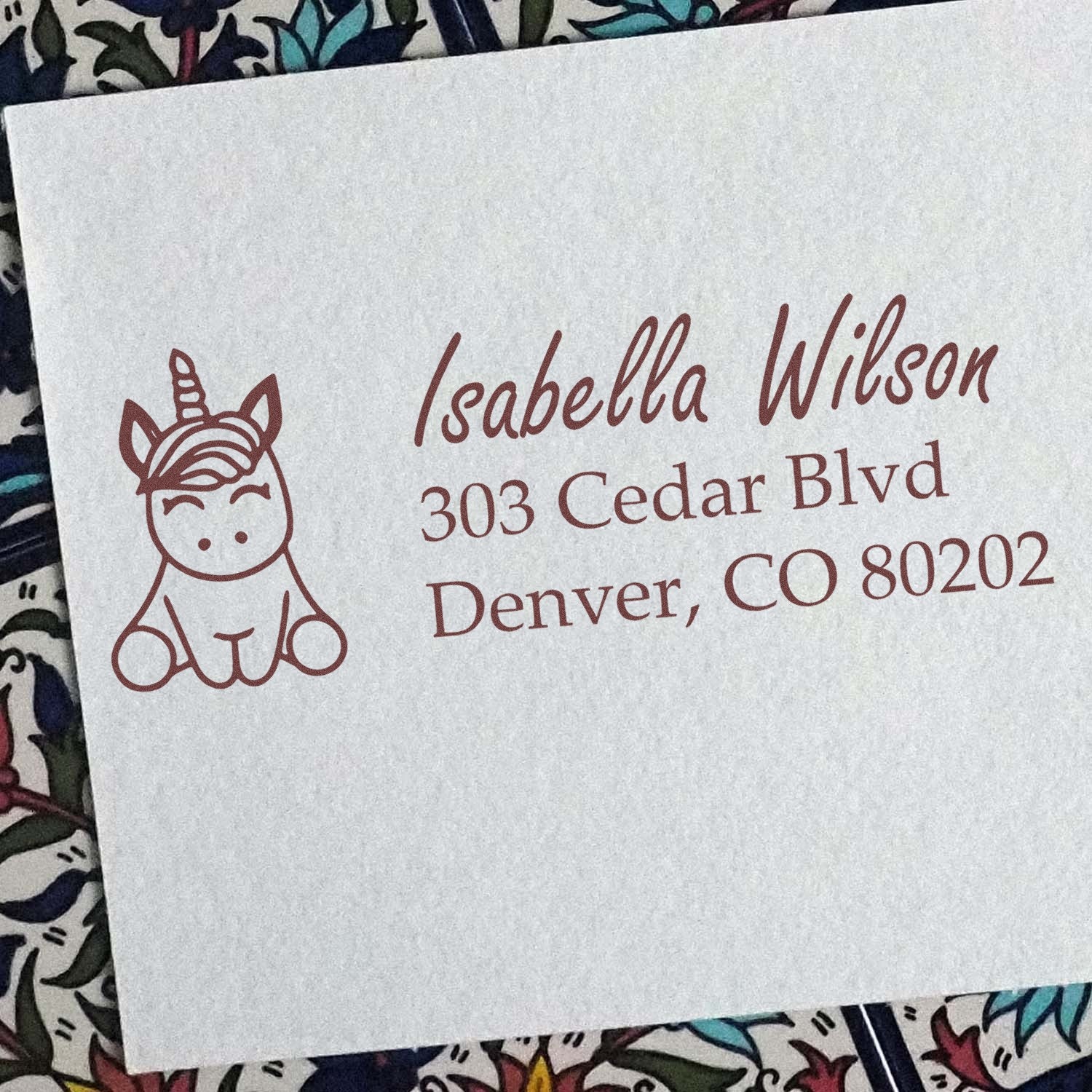 Personalized unicorn return address rubber stamp for Isabella Wilson, Denver, CO.