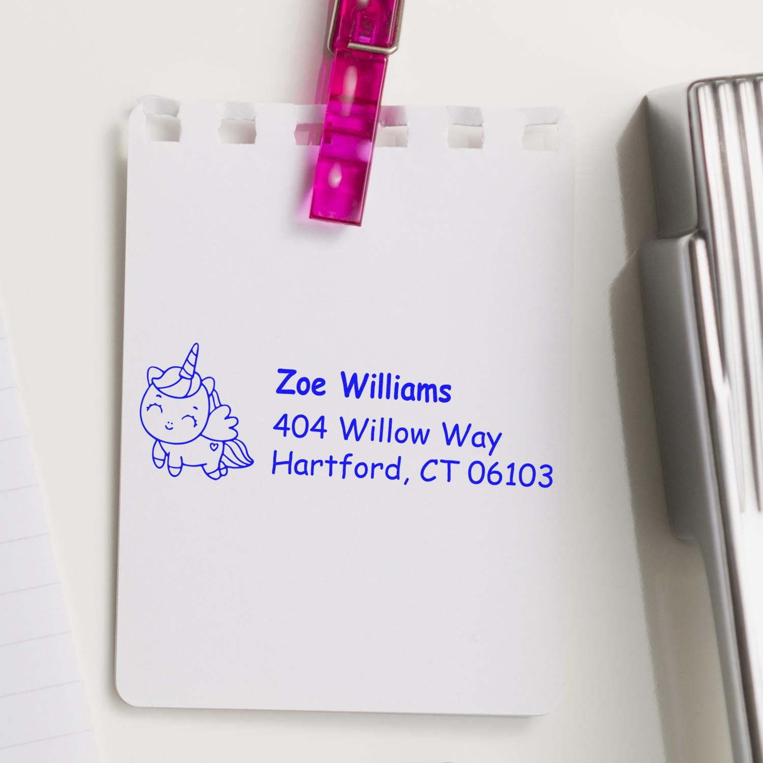 Custom unicorn return address rubber stamp in blue ink for Zoe Williams, Hartford, CT on a white card.