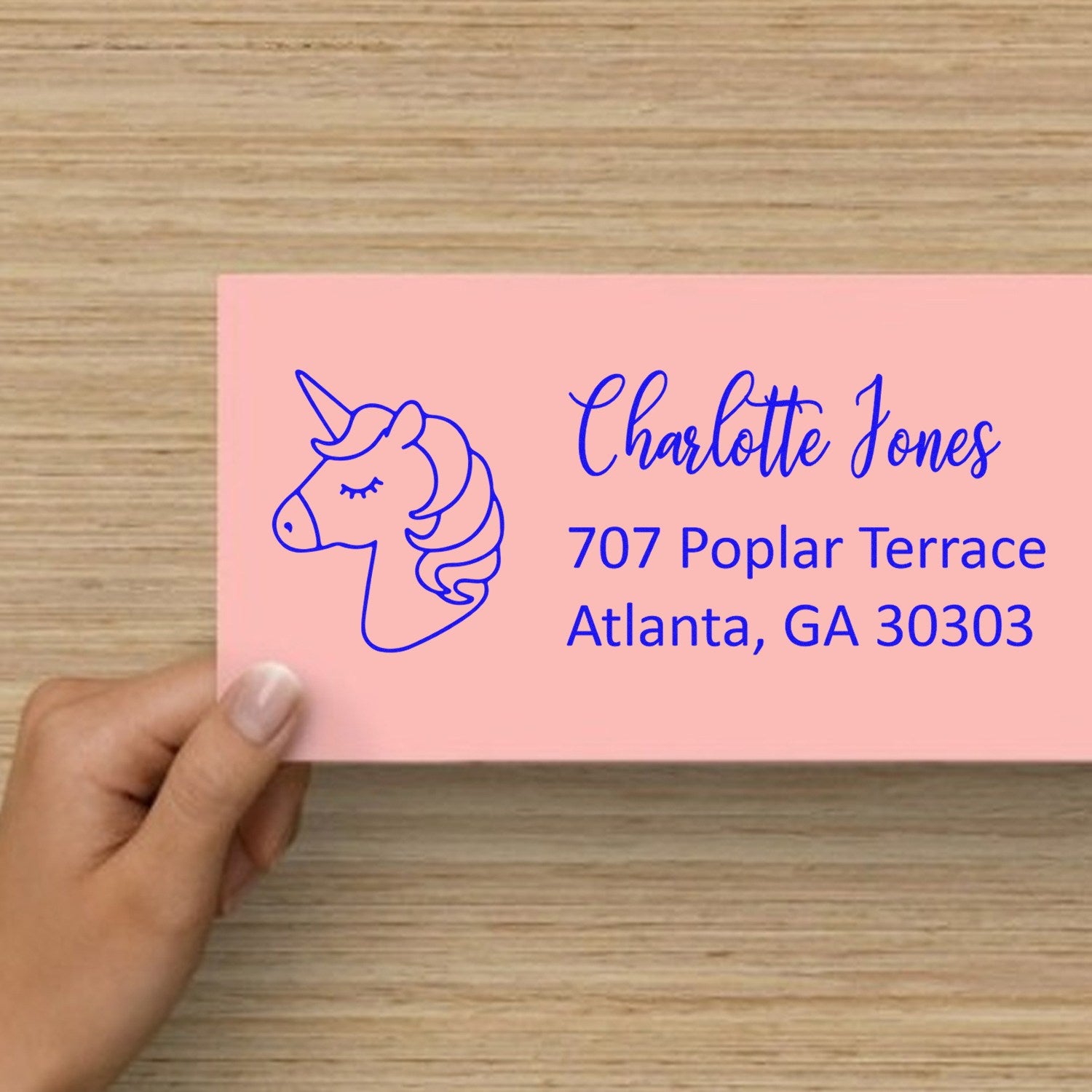 Personalized unicorn return address rubber stamp on a pink envelope with Charlotte Jones and Atlanta, GA address.