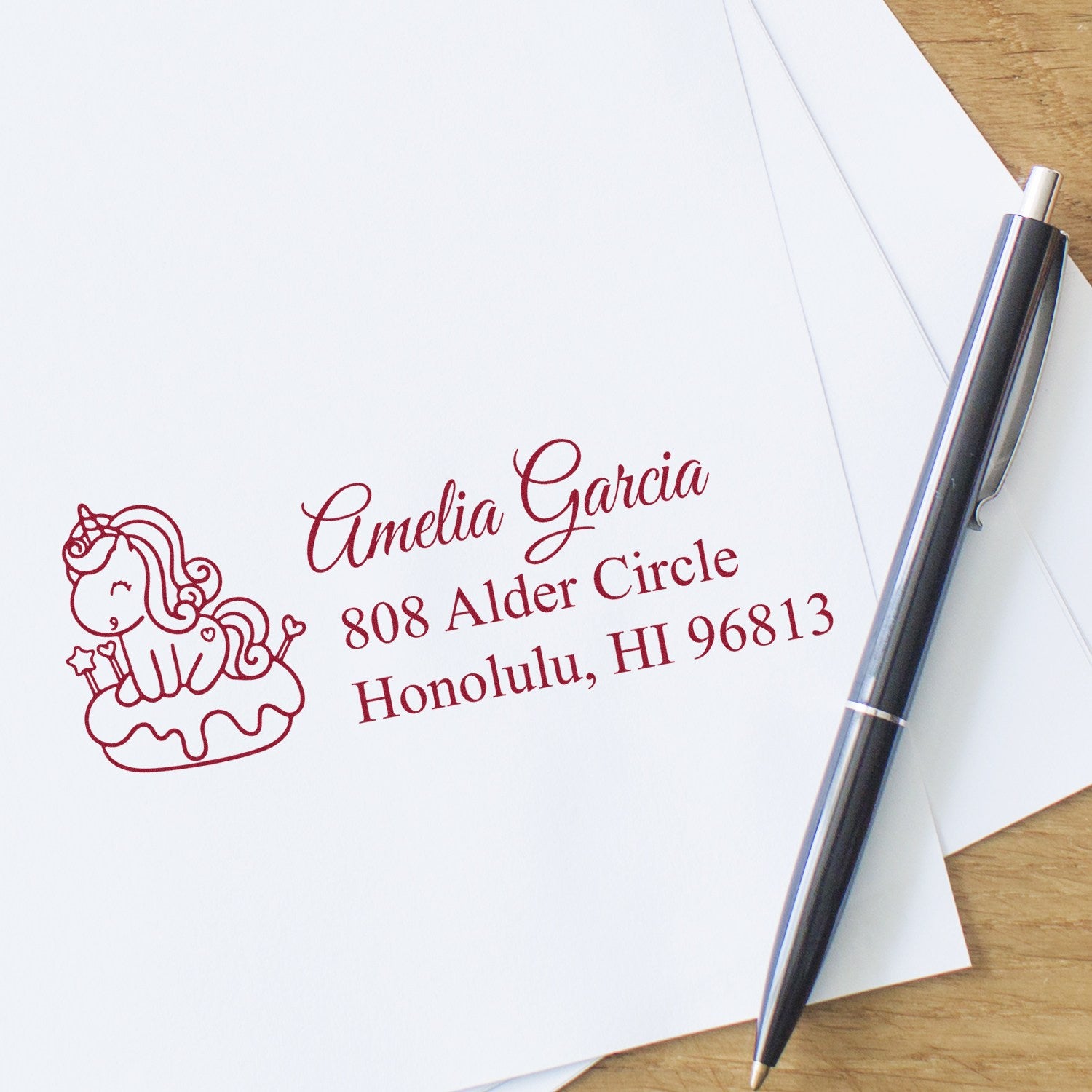 Custom unicorn address rubber stamp for personalized stationery, shown on envelopes with red ink imprint.