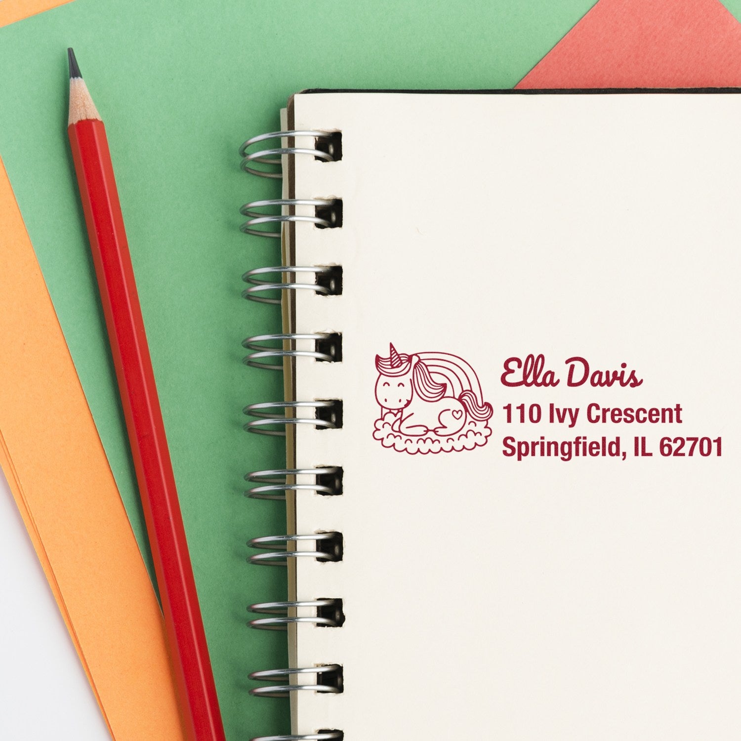 Custom unicorn return address rubber stamp with name and address on notebook, ideal for mailing and crafting.