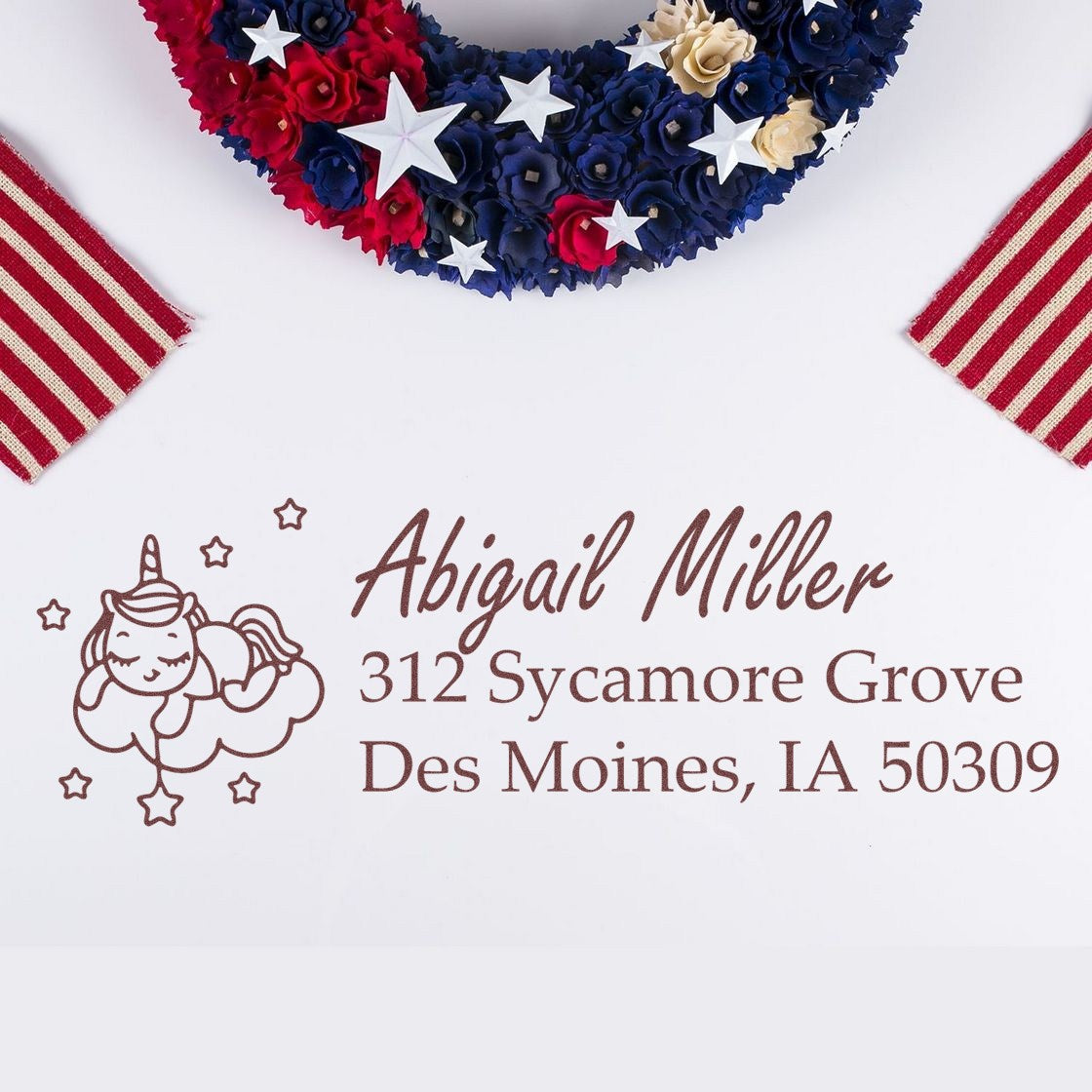 Personalized unicorn return address rubber stamp for Abigail Miller, with Des Moines, IA address on white paper.
