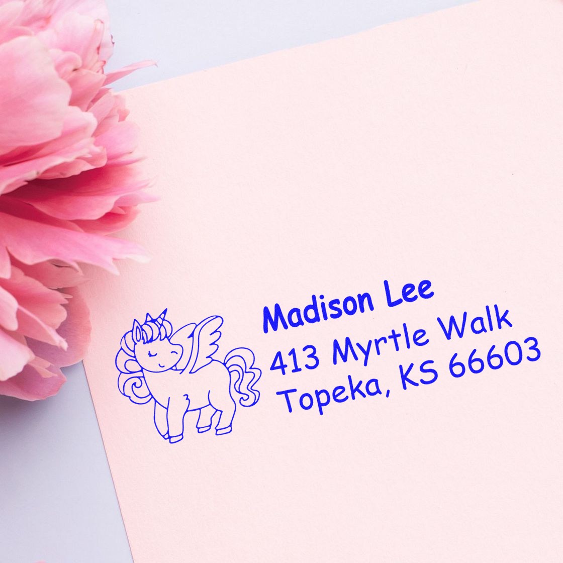 Personalized unicorn return address rubber stamp on pink stationery for Madison Lee, 413 Myrtle Walk, Topeka KS 66603.