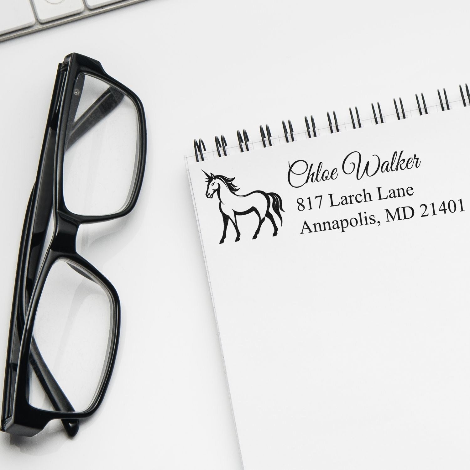 Personalized rubber address stamp with horse design on notepad, ideal for custom mailing labels and stationery.