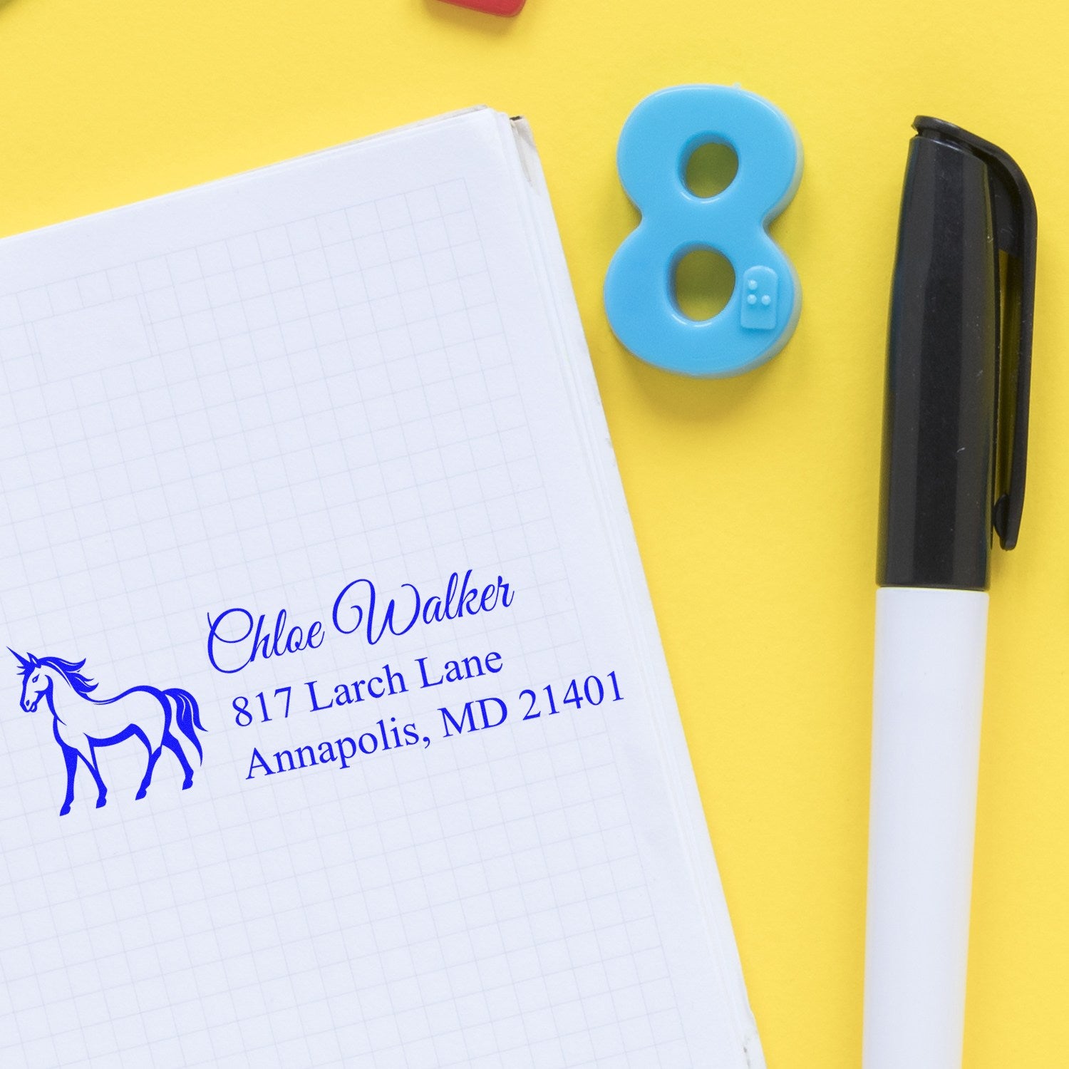 Personalized address rubber stamp with horse design, stamped on notebook paper for custom stationery and mailing labels.