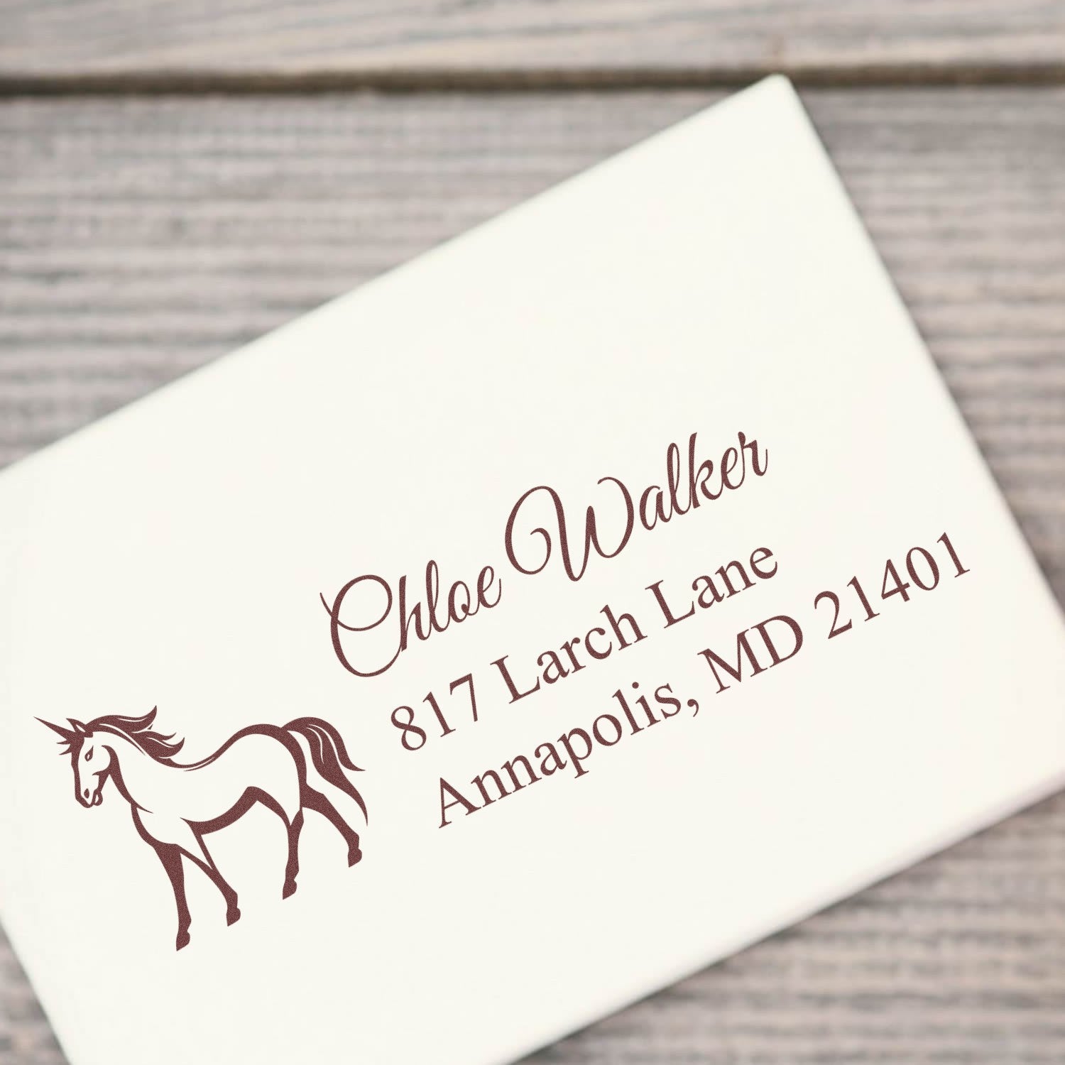 Custom horse return address rubber stamp for Chloe Walker in Annapolis, MD on a wedding envelope.