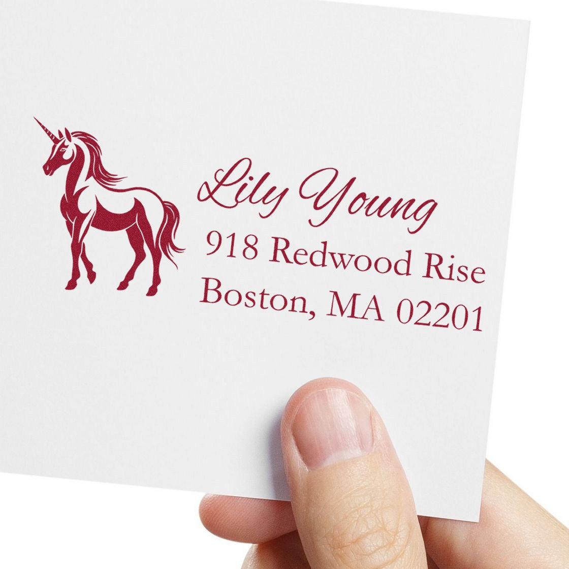 Personalized unicorn address rubber stamp with name and Boston, MA mailing address on white envelope.