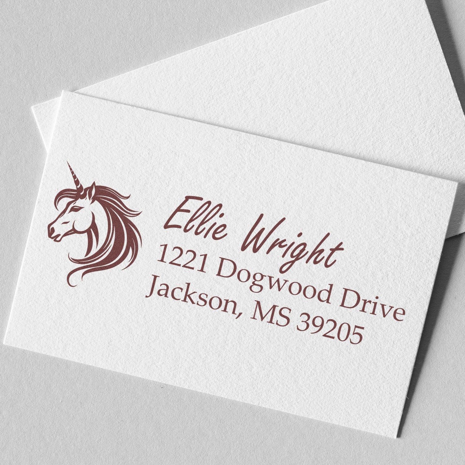 Custom rubber stamp with unicorn logo and return address for Ellie Wright, 1221 Dogwood Drive, Jackson, MS