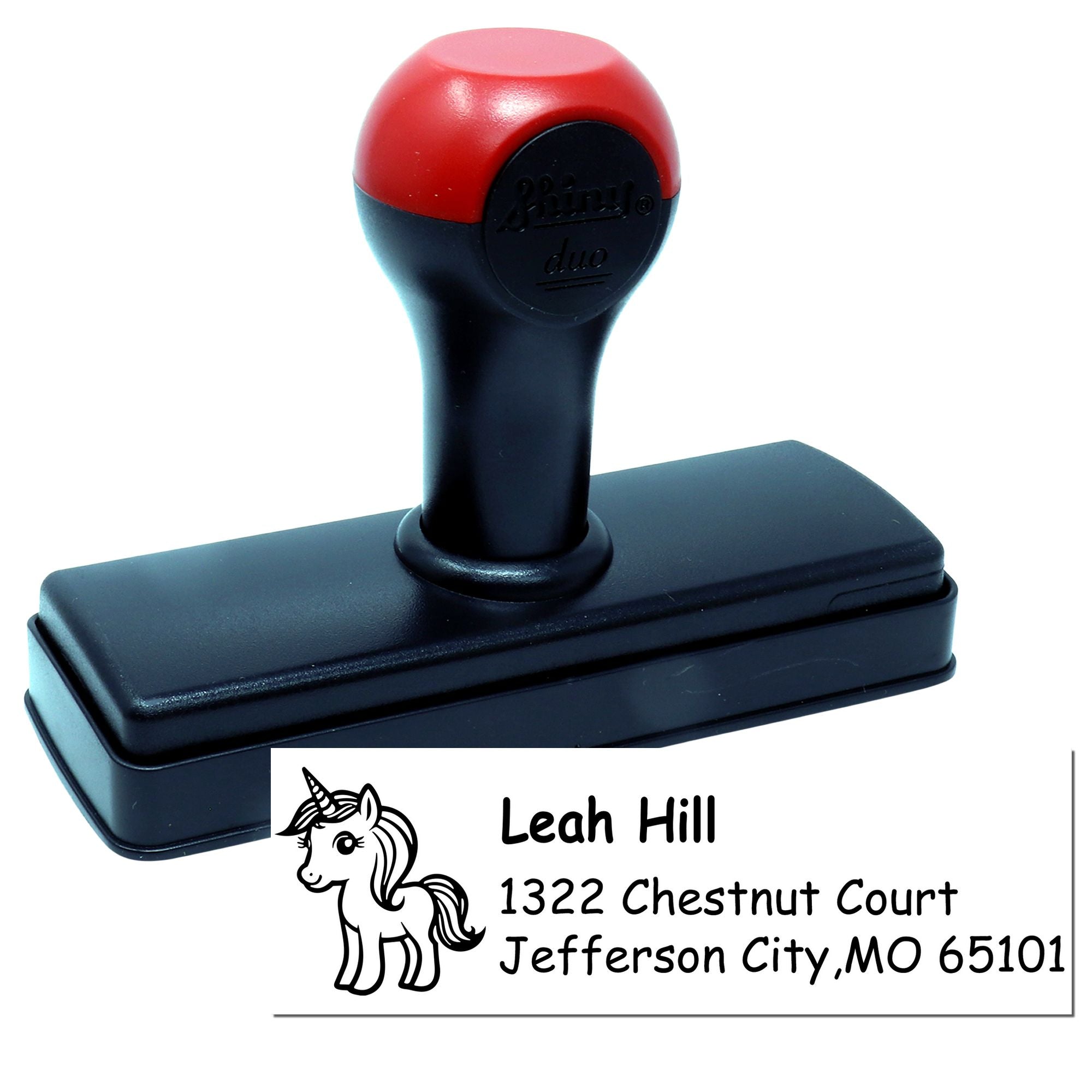 Custom self-inking rubber address stamp with unicorn design and sample personalized name-and-address imprint.