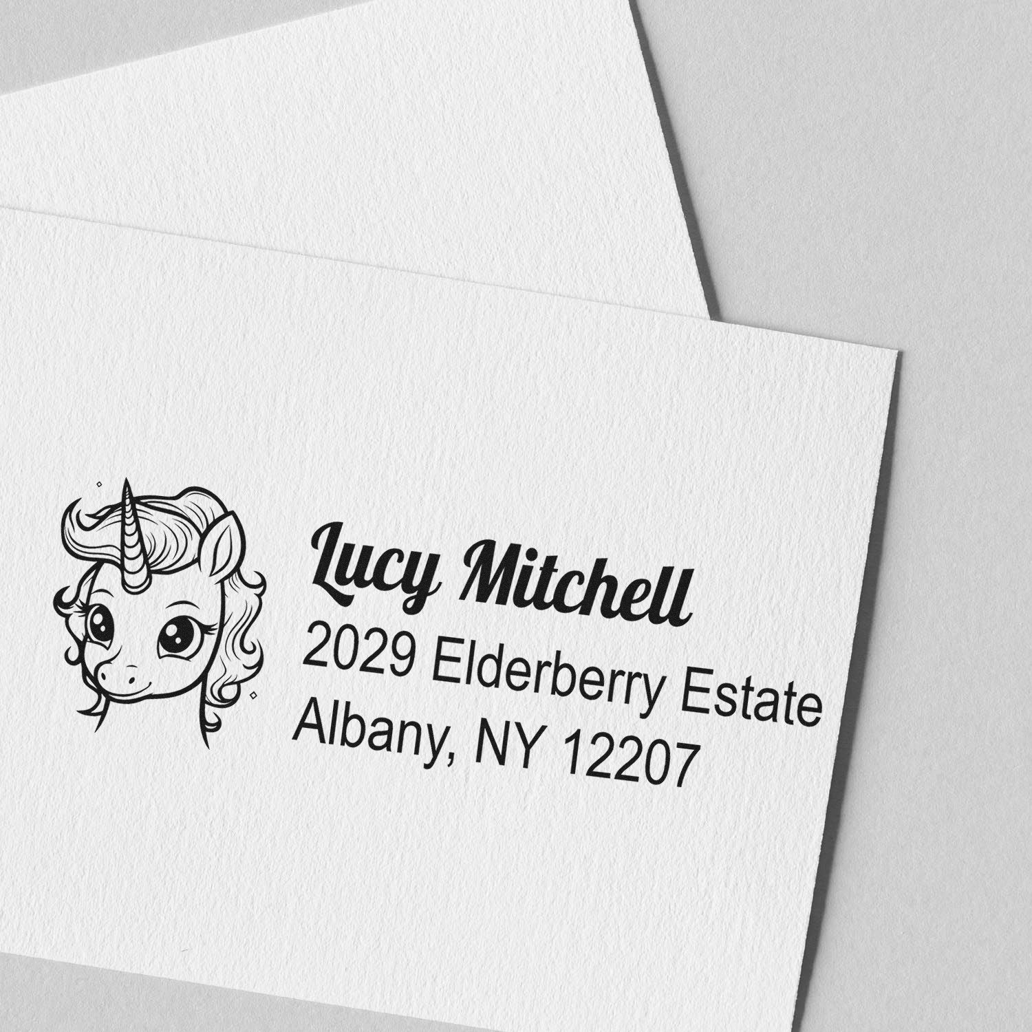 Personalized unicorn rubber stamp with return address for Lucy Mitchell, 2029 Elderberry Estate, Albany, NY 12207
