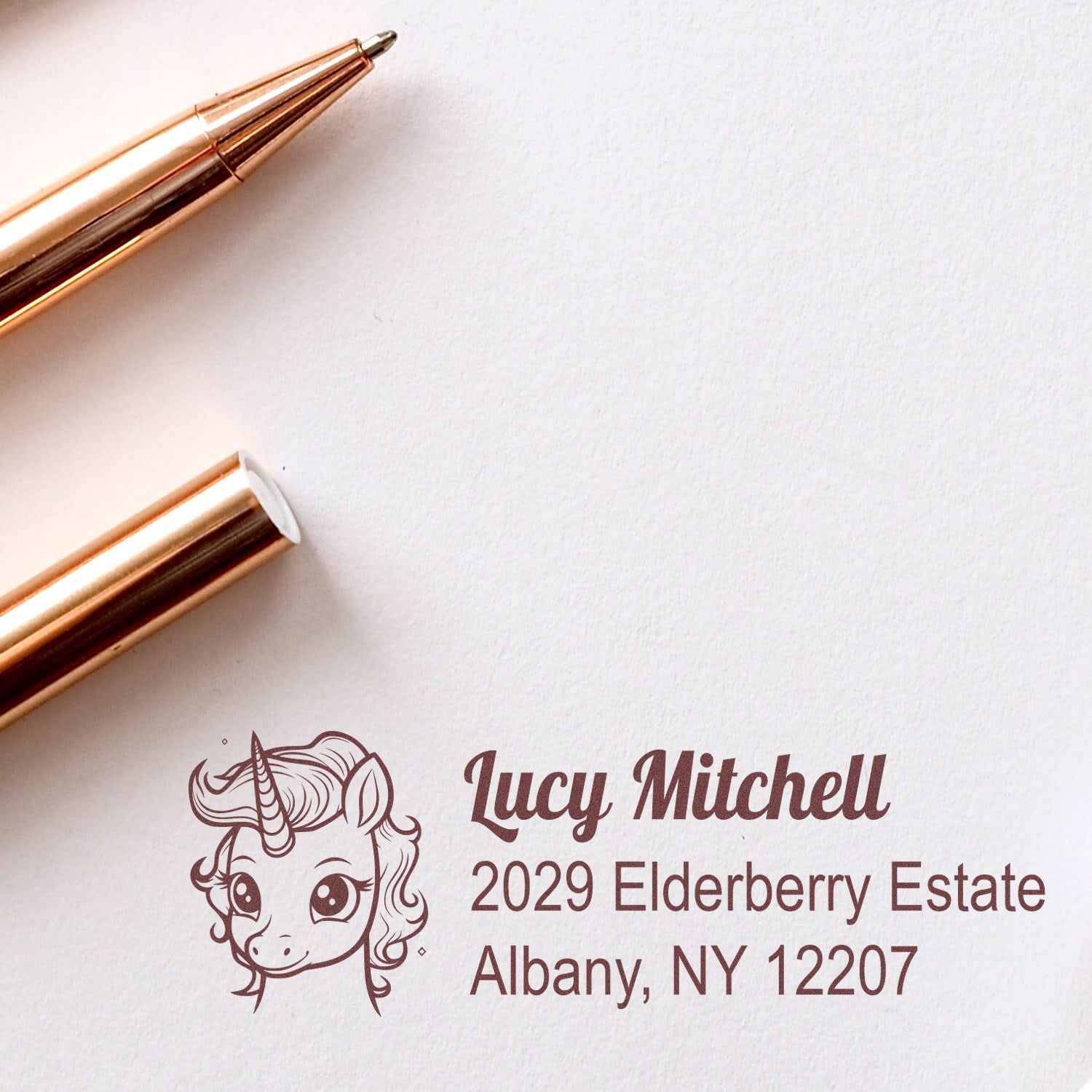 Custom unicorn return address rubber stamp with personalized name and Albany, NY address for stationery and envelopes.