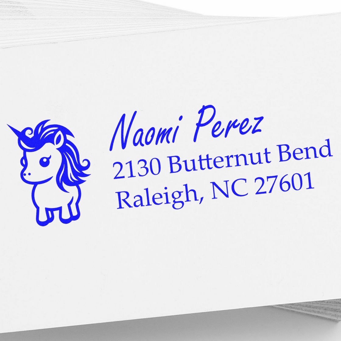 Personalized unicorn address rubber stamp for Naomi Perez, 2130 Butternut Bend, Raleigh, NC 27601.