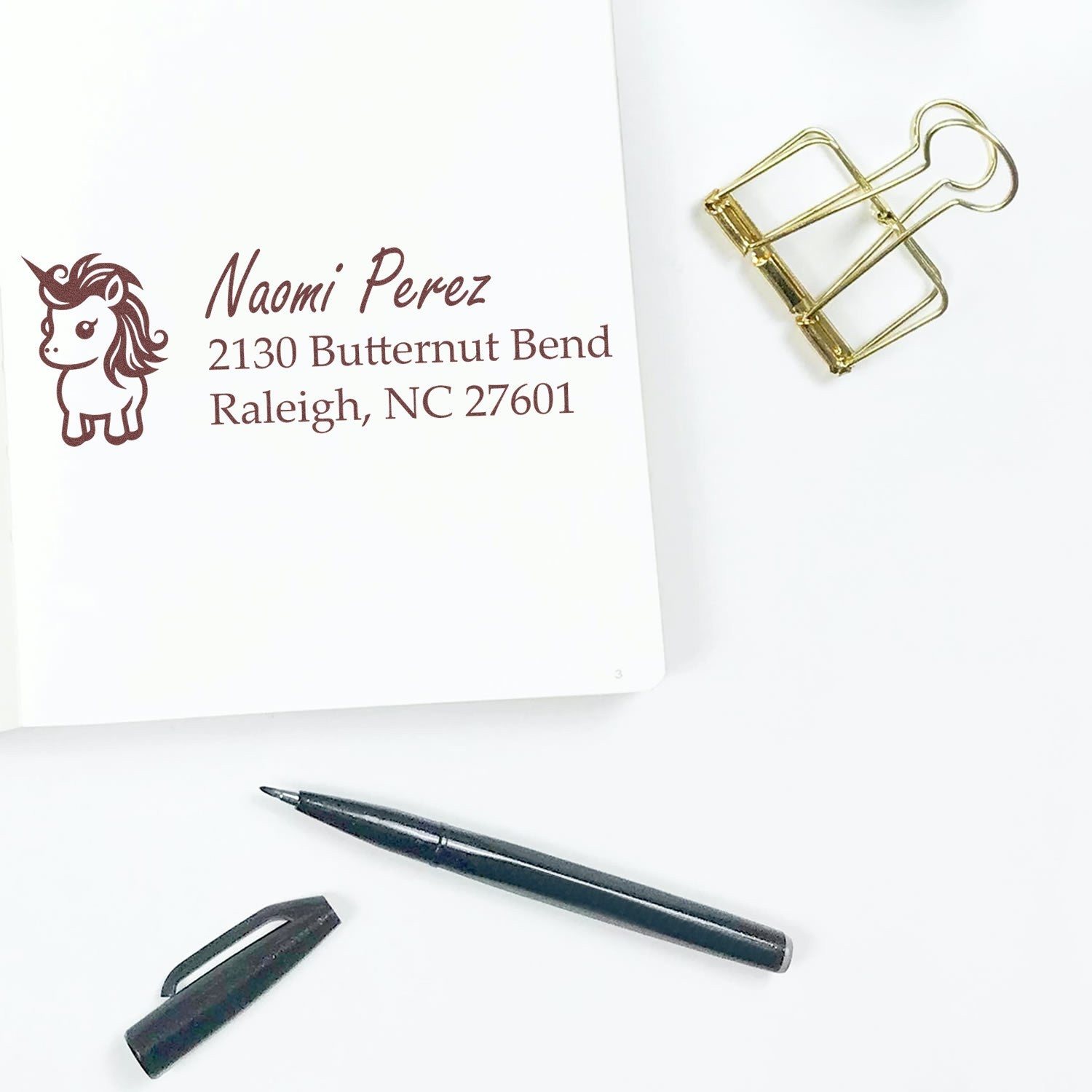 Personalized unicorn return address rubber stamp with name and address imprint for mailing and stationery.