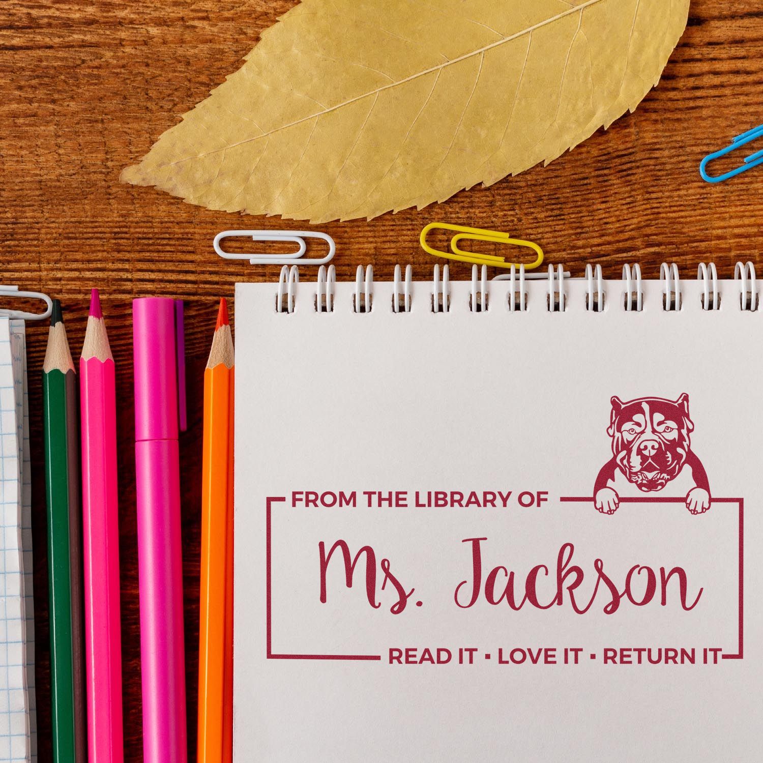 Custom library rubber stamp for Ms. Jackson with bulldog design, perfect for teacher book labels and return reminders.