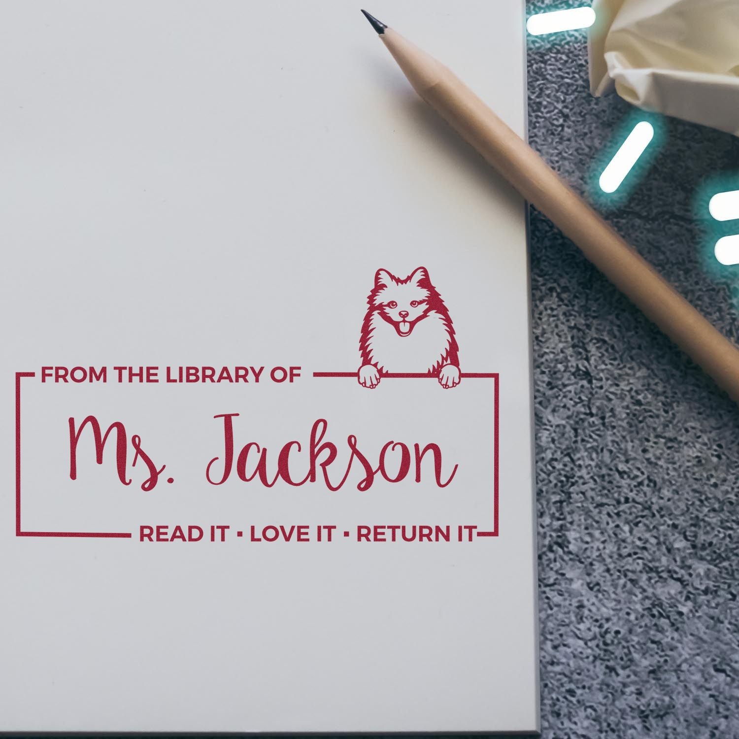 Personalized library rubber stamp reading From the library of Ms. Jackson with fox design for book ownership and return.