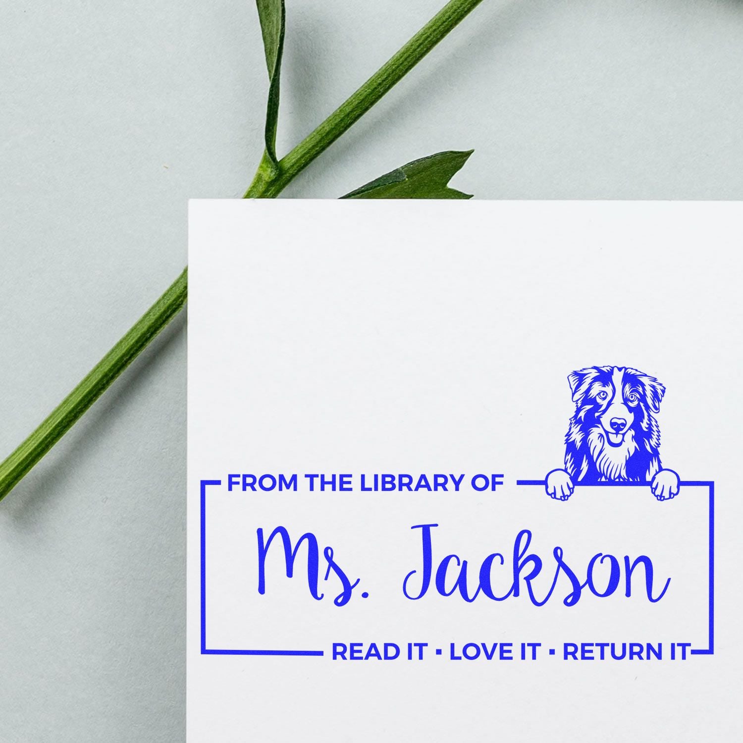 Personalized library rubber stamp for Ms. Jackson with dog bookplate design and Read it, Love it, Return it message.
