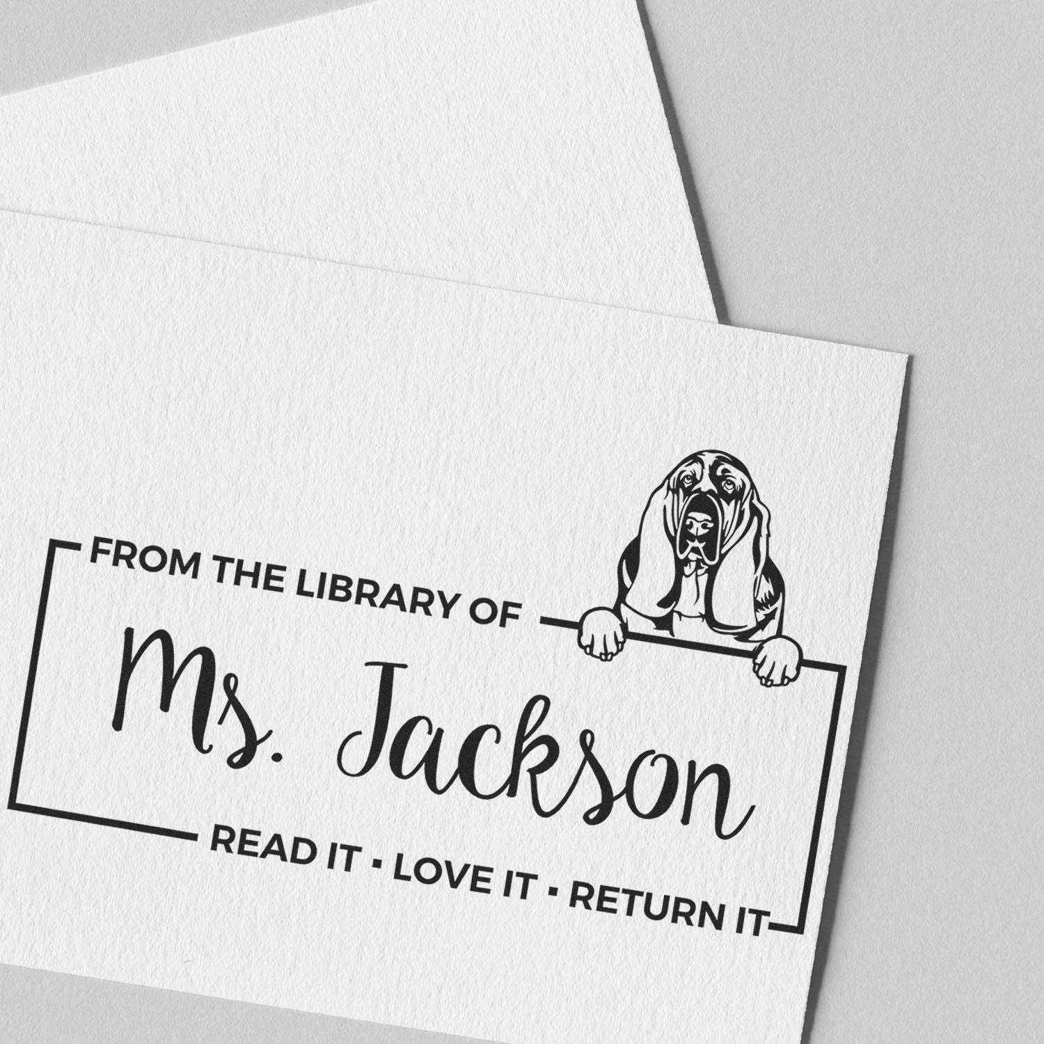 Custom rubber library book stamp with basset hound design for Ms. Jackson, reading Read it, love it, return it.