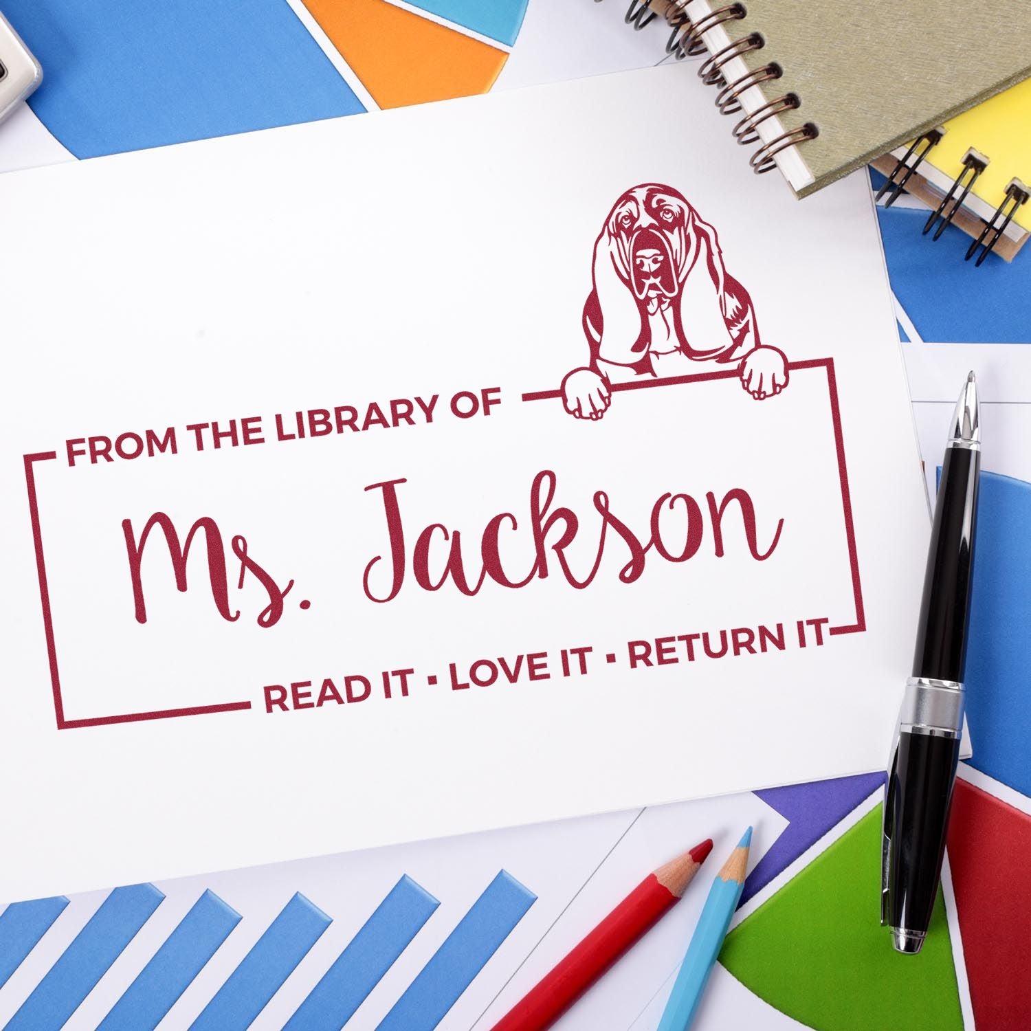 Custom library rubber stamp for Ms. Jackson, with dog icon and Read it, Love it, Return it bookplate on stationery.