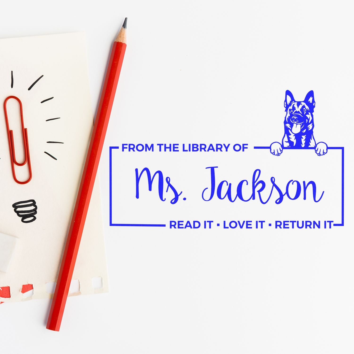 Personalized library rubber stamp for Ms. Jackson with dog artwork and Read It, Love It, Return It bookplate text.