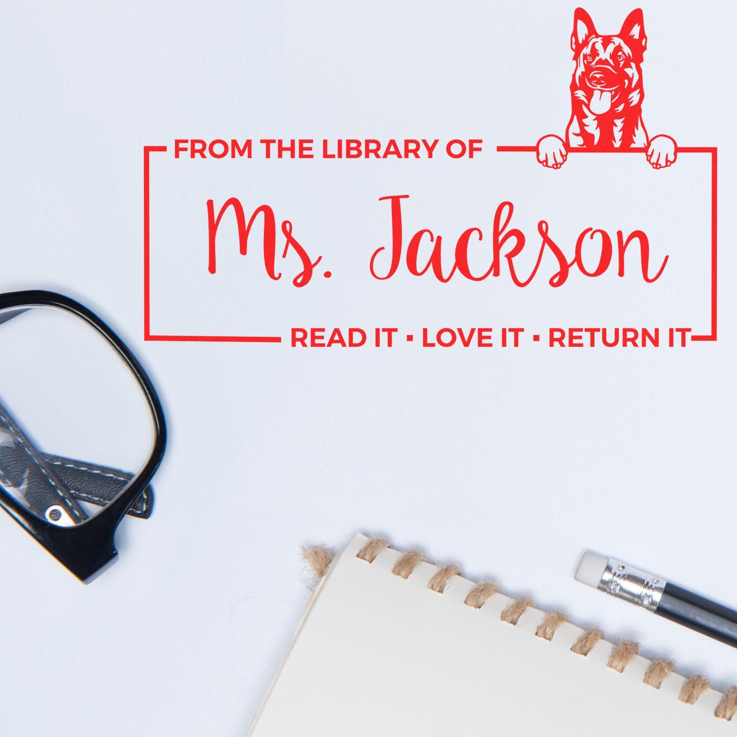 Custom library rubber stamp for Ms. Jackson with dog bookplate and Read it, love it, return it message.