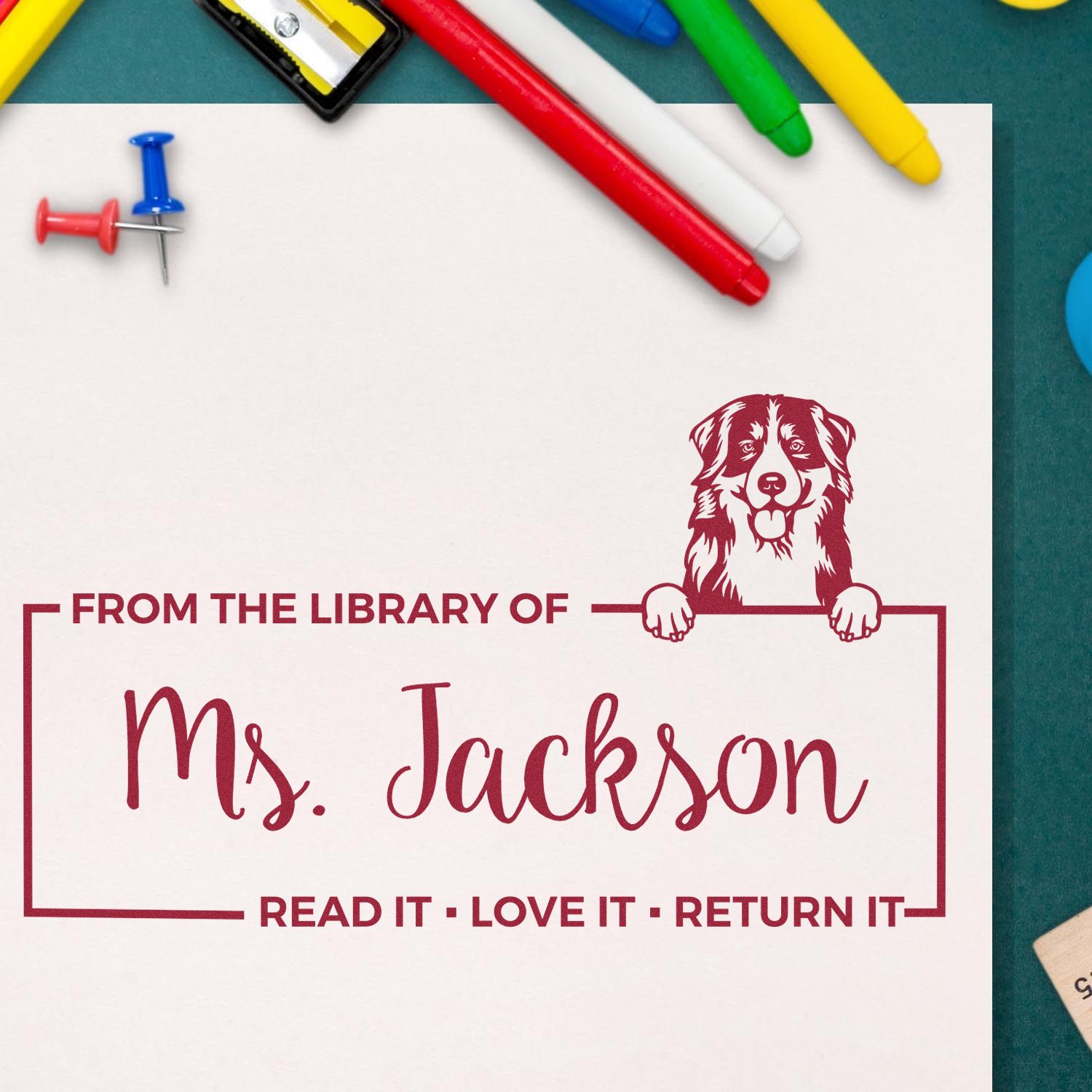 Custom library rubber stamp with dog design and personalized name, Ms. Jackson, for book plates and return labels.