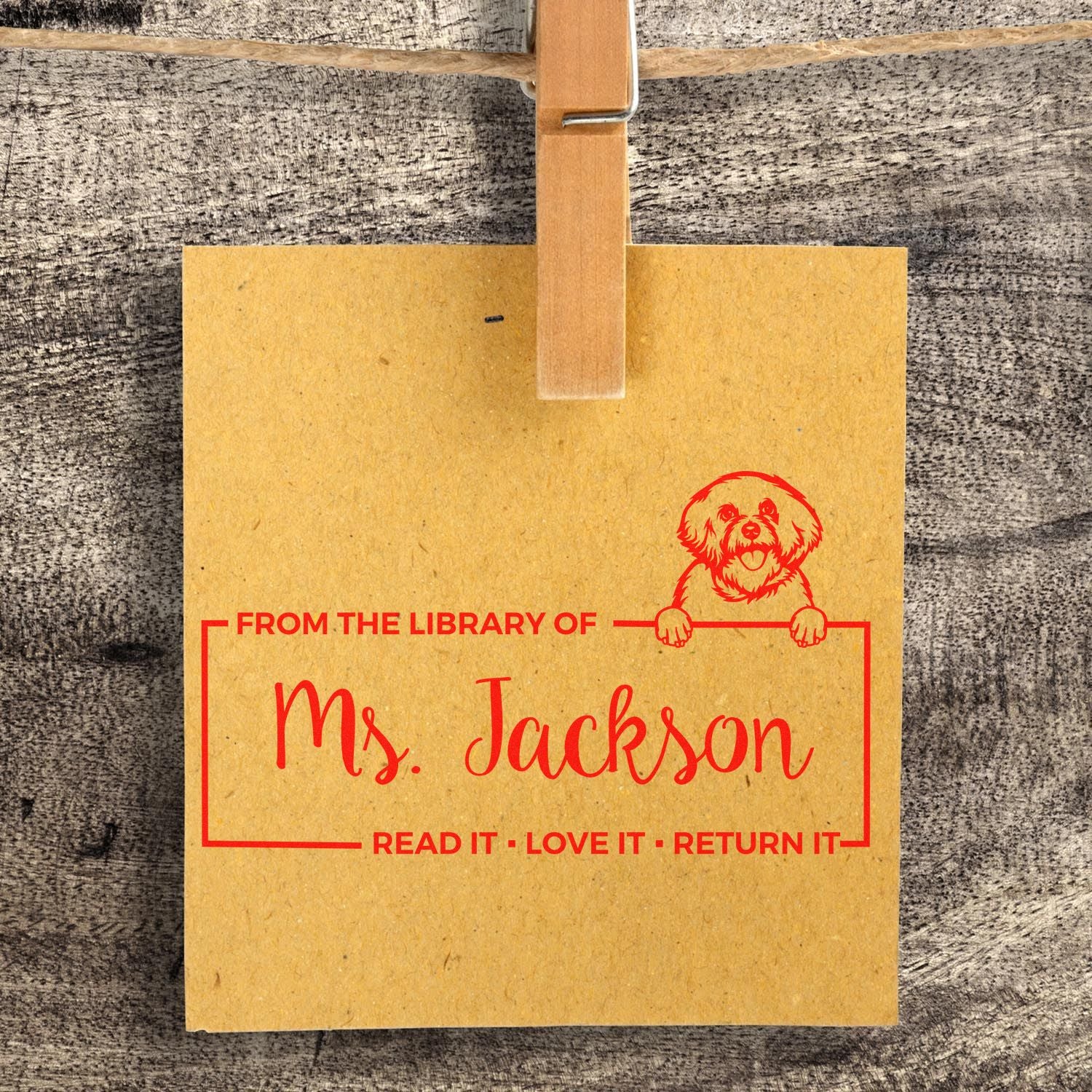 Custom library rubber stamp for Ms. Jackson with dog illustration and Read It, Love It, Return It bookplate message.