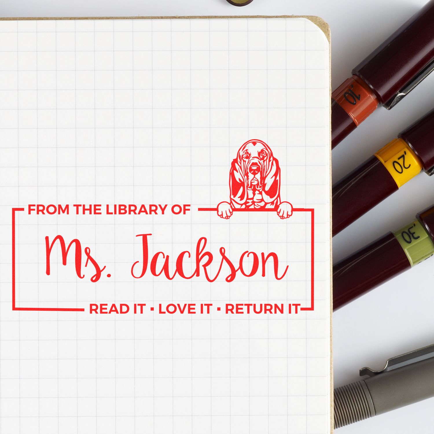 Custom self-inking rubber stamp with dog design for library books: From the Library of Ms. JacksonRead It, Love It, Return It.