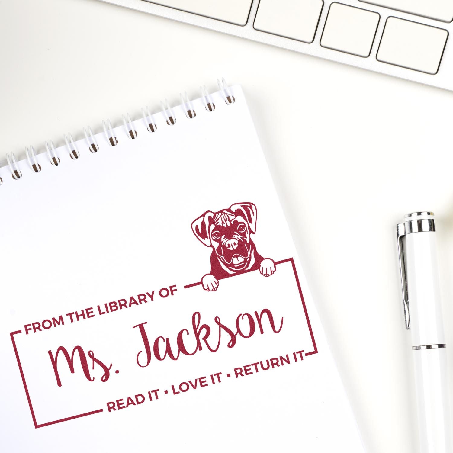 Custom library rubber stamp with dog design and From the Library of Ms. Jackson book return message.