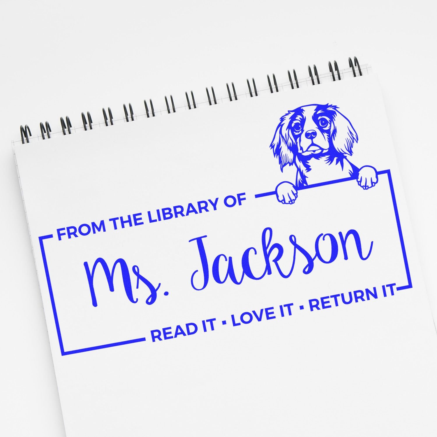 Custom rubber book stamp for Ms. Jackson featuring a dog illustration and Read it, love it, return it library message.