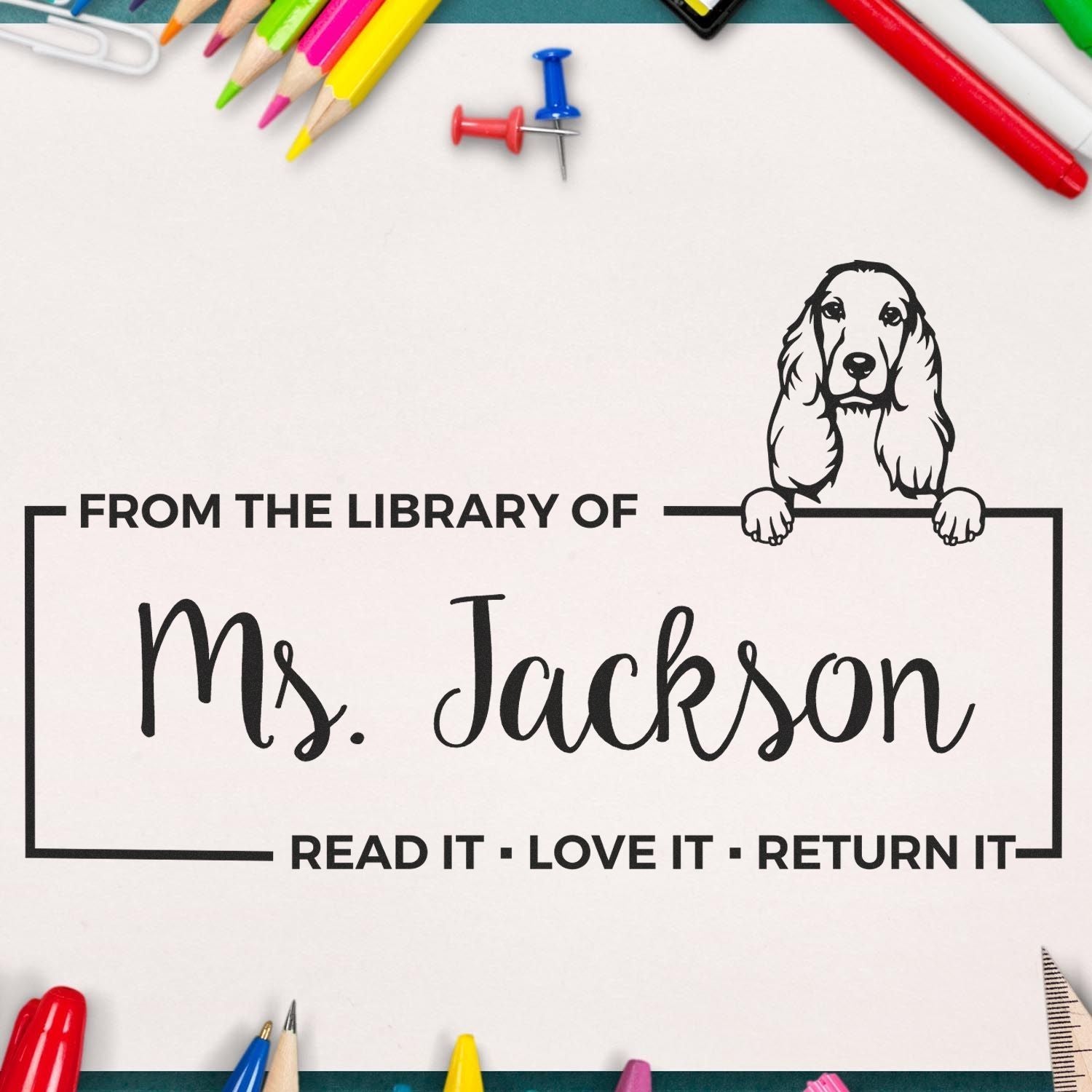Custom rubber stamp with dog illustration and From the Library of Ms. Jackson for personalized library book labeling.