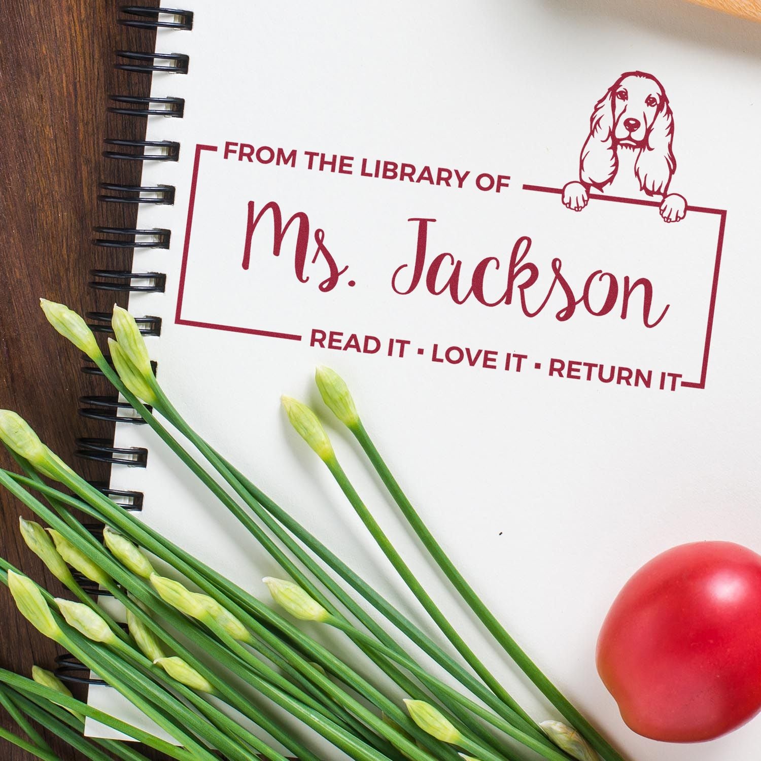 Personalized library rubber stamp for books, reading From the Library of Ms. Jackson with dog illustration.