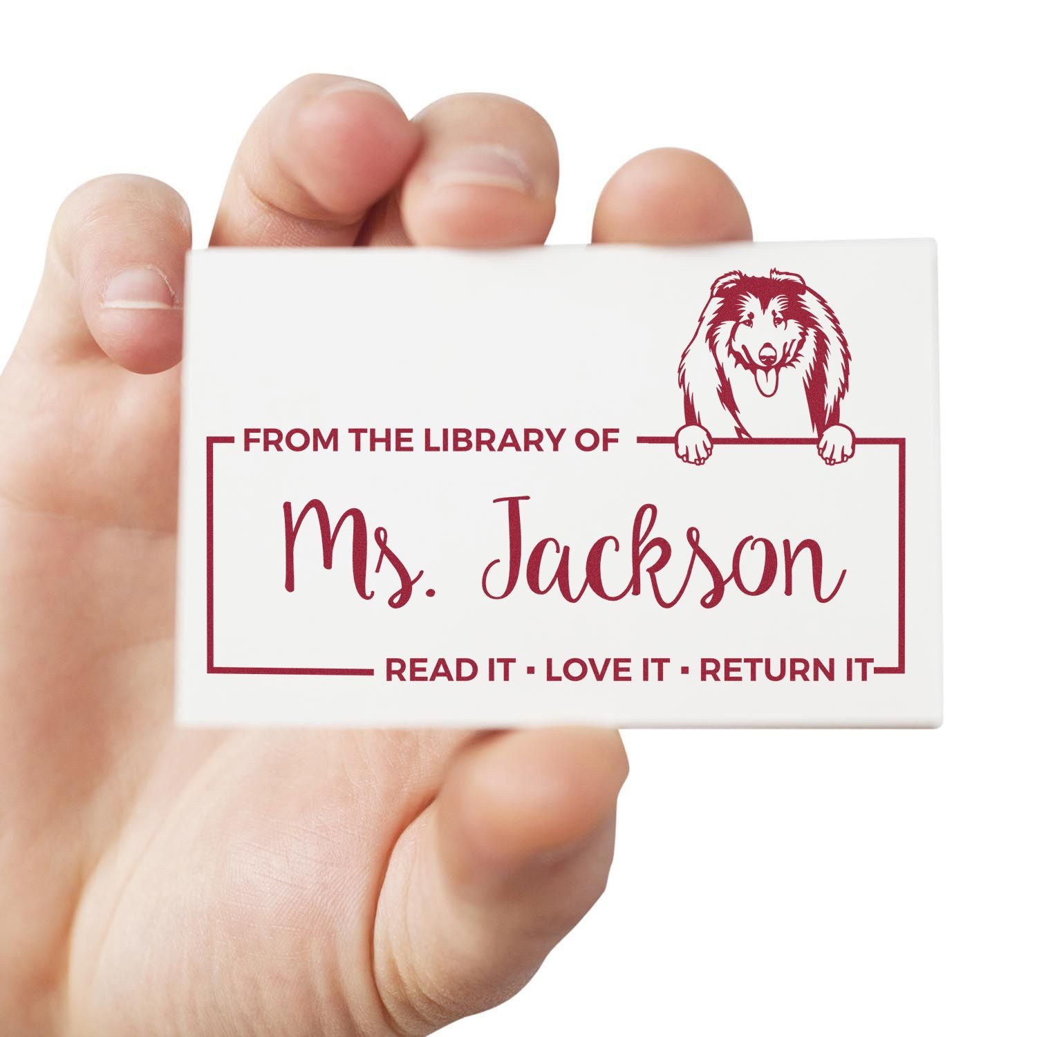 Personalized library rubber stamp for Ms. Jackson with dog illustration and bookplate return message.