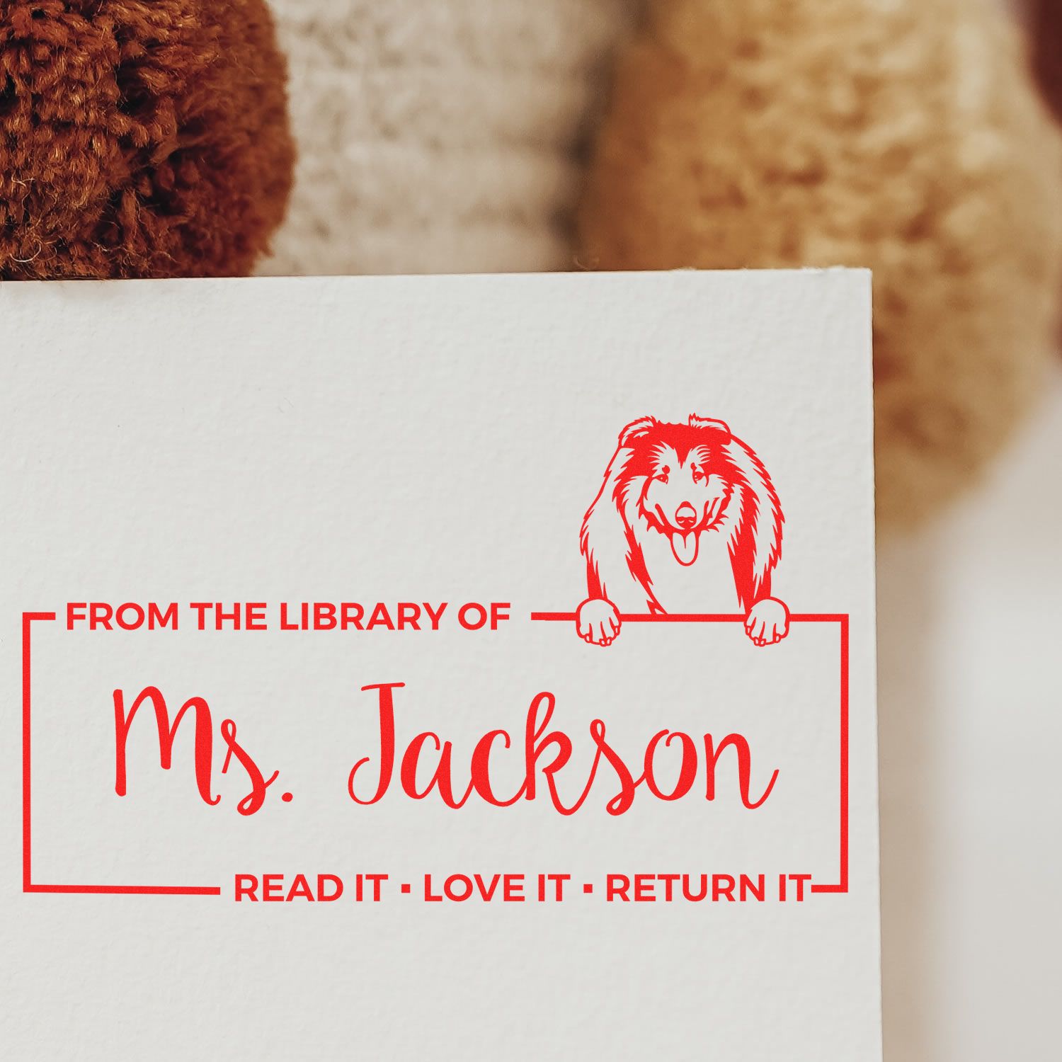 Personalized library rubber stamp for Ms. Jackson with dog design and Read it, Love it, Return it bookplate text.
