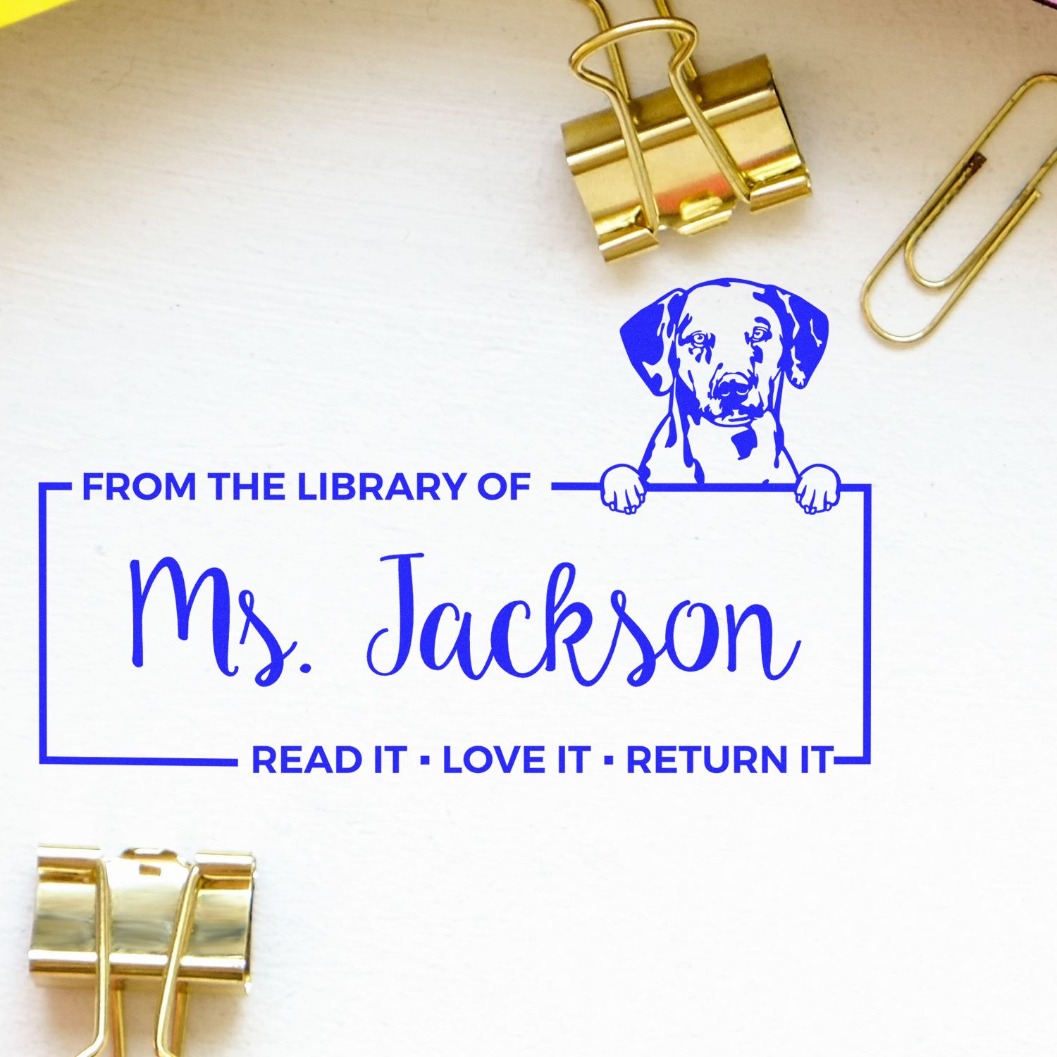 Personalized rubber library stamp for books, reading From the Library of Ms. Jackson with dog design and return message.