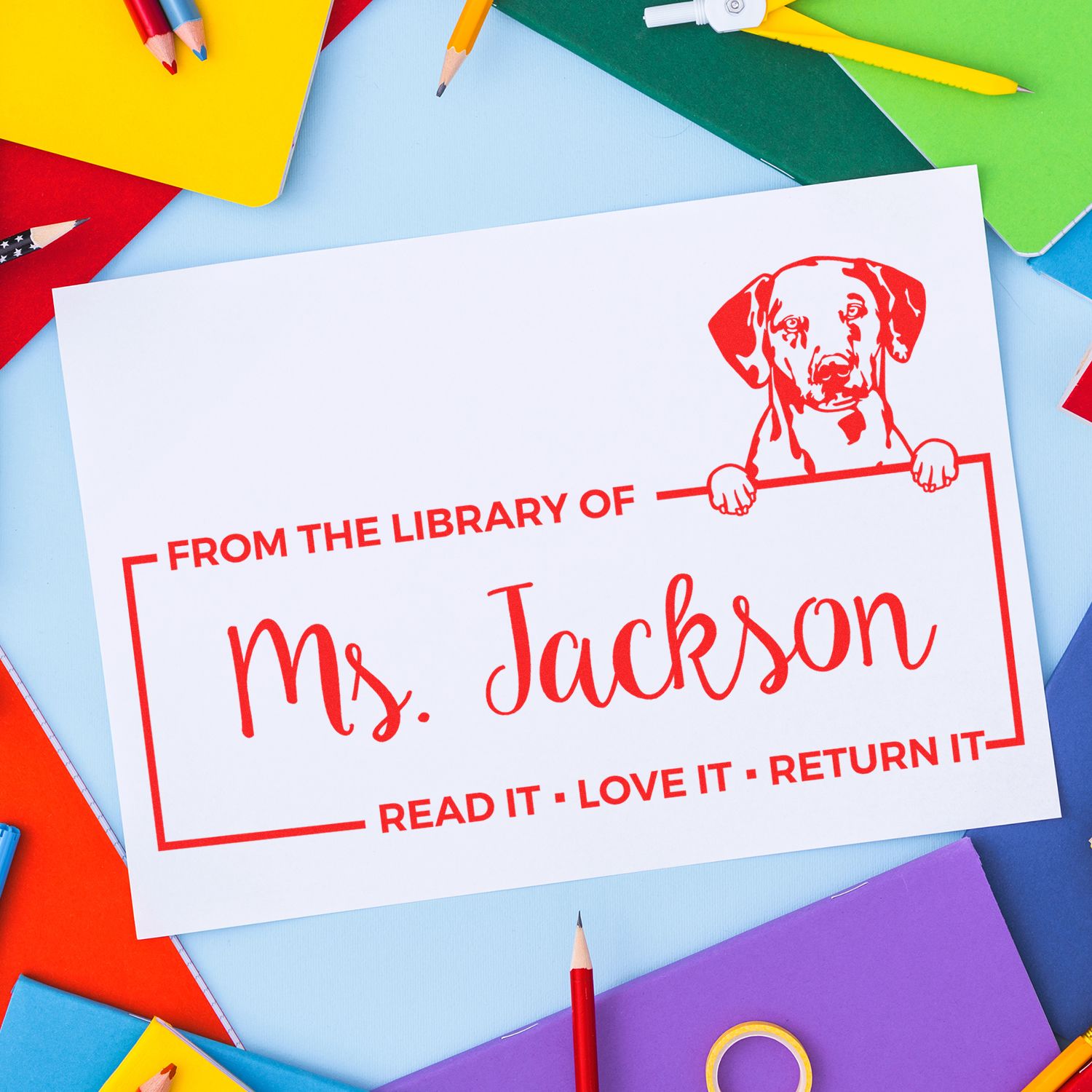 Custom rubber library stamp for Ms. Jackson, with dog logo, to mark school books and remind readers to return them.