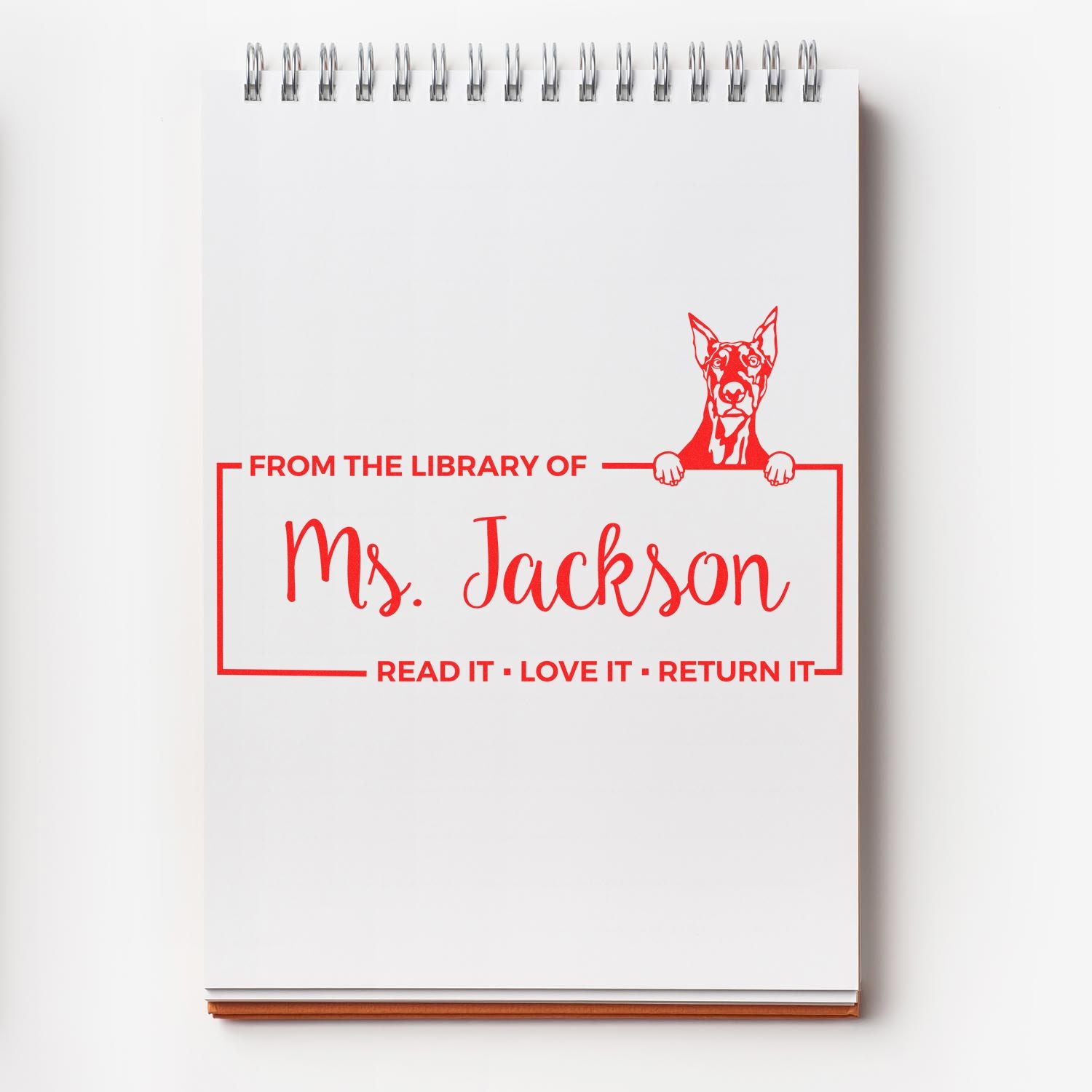 Personalized library rubber stamp for books, reading From the Library of Ms. Jackson with a dog and return reminder.
