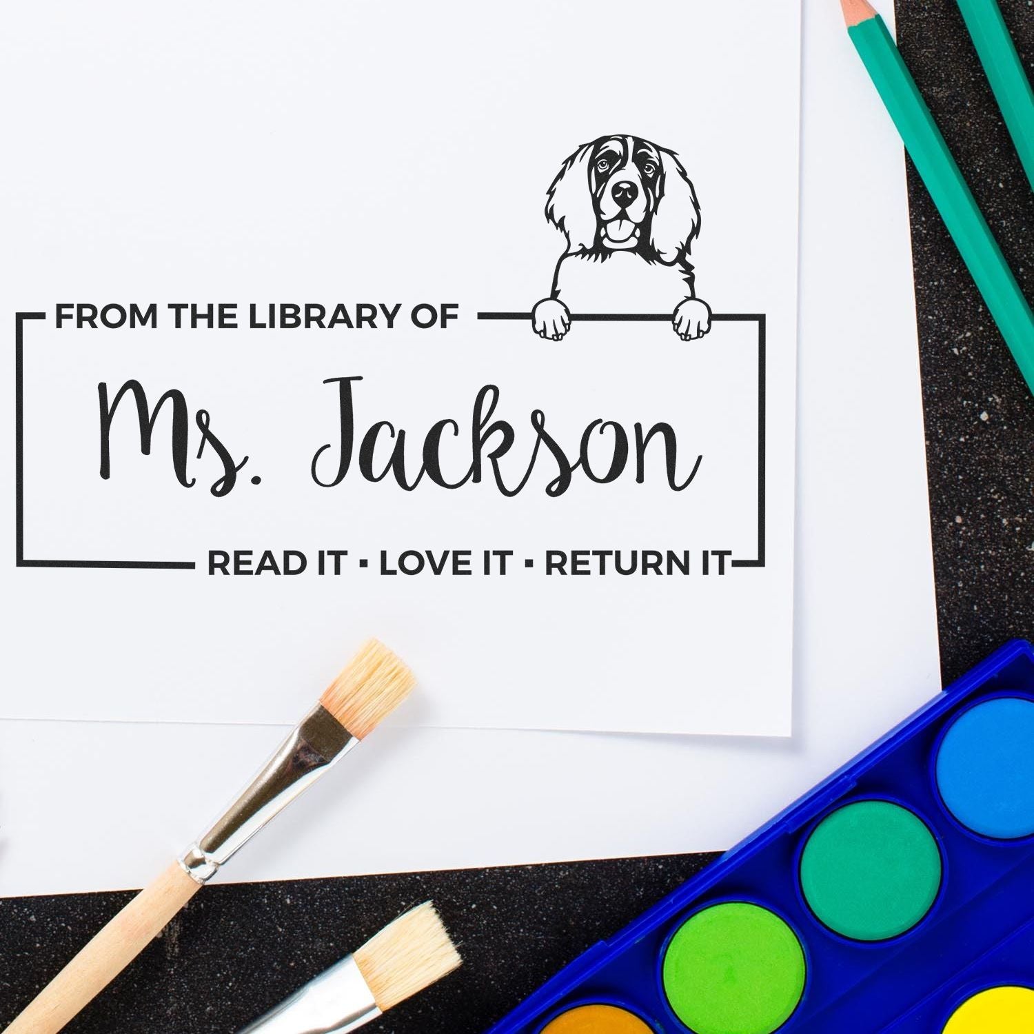 Custom library book rubber stamp with dog design for Ms. Jackson, with Read It, Love It, Return It reminder.