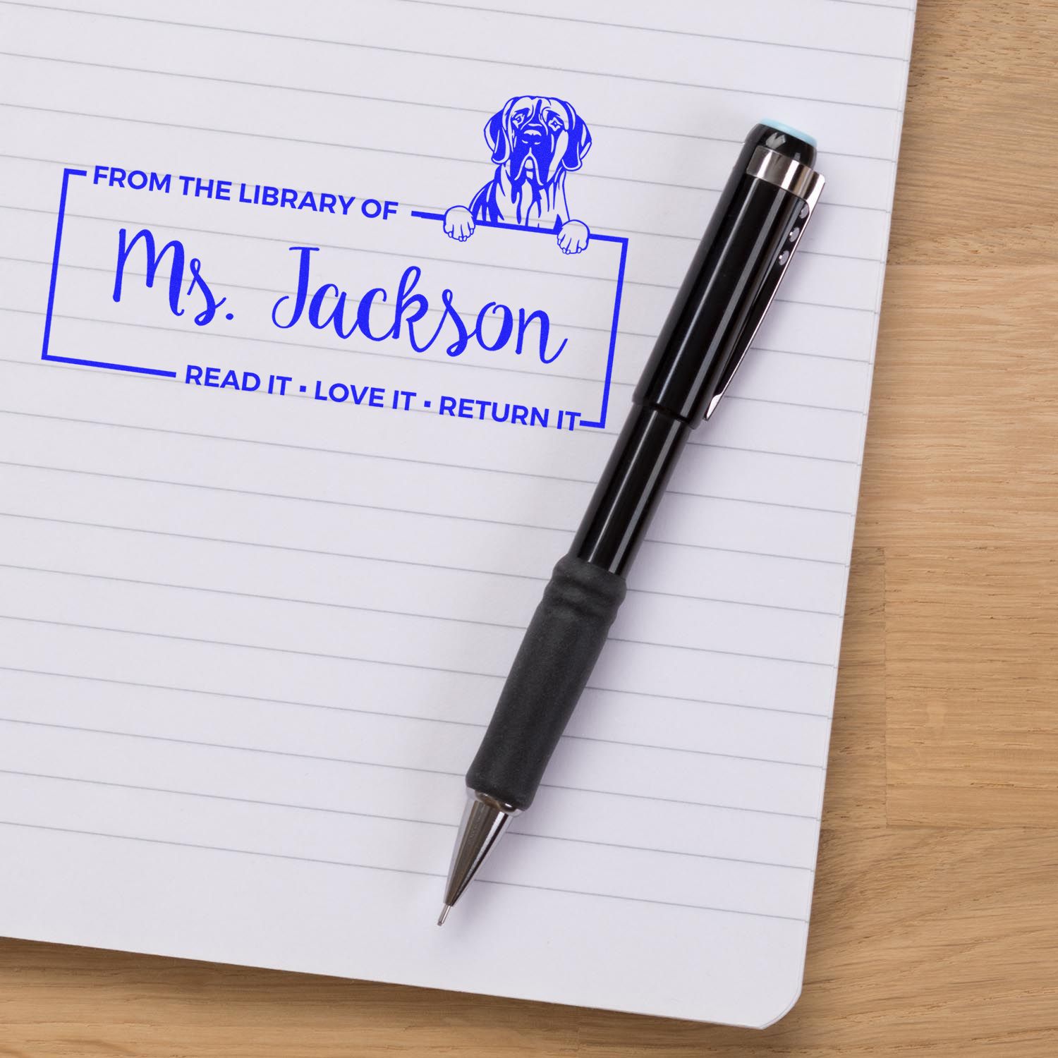Personalized library rubber stamp for Ms. Jackson with dog design, marking books Read it, Love it, Return it.