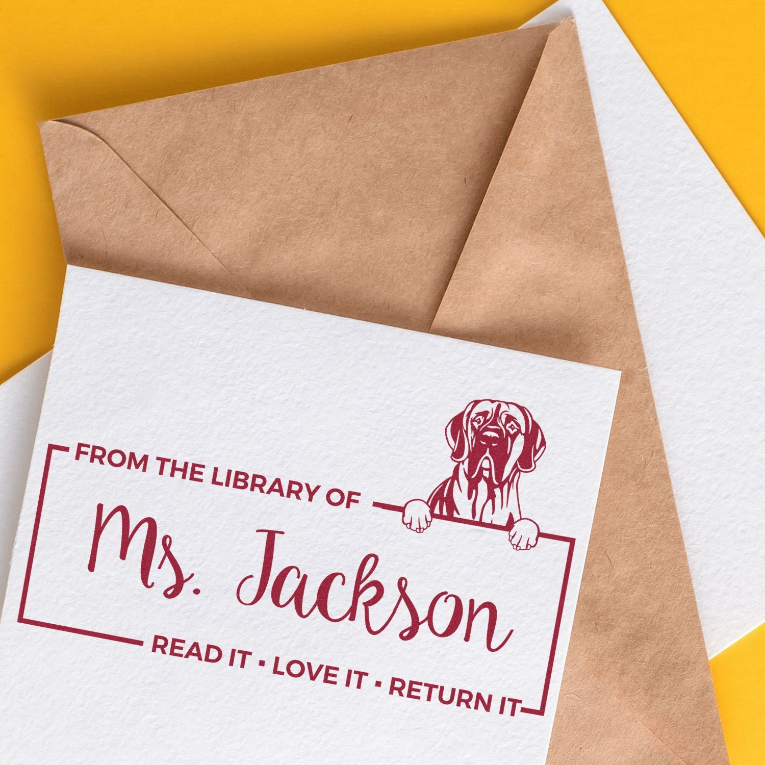 Custom rubber library stamp for book return labels, reading From the Library of Ms. Jackson with dog illustration.