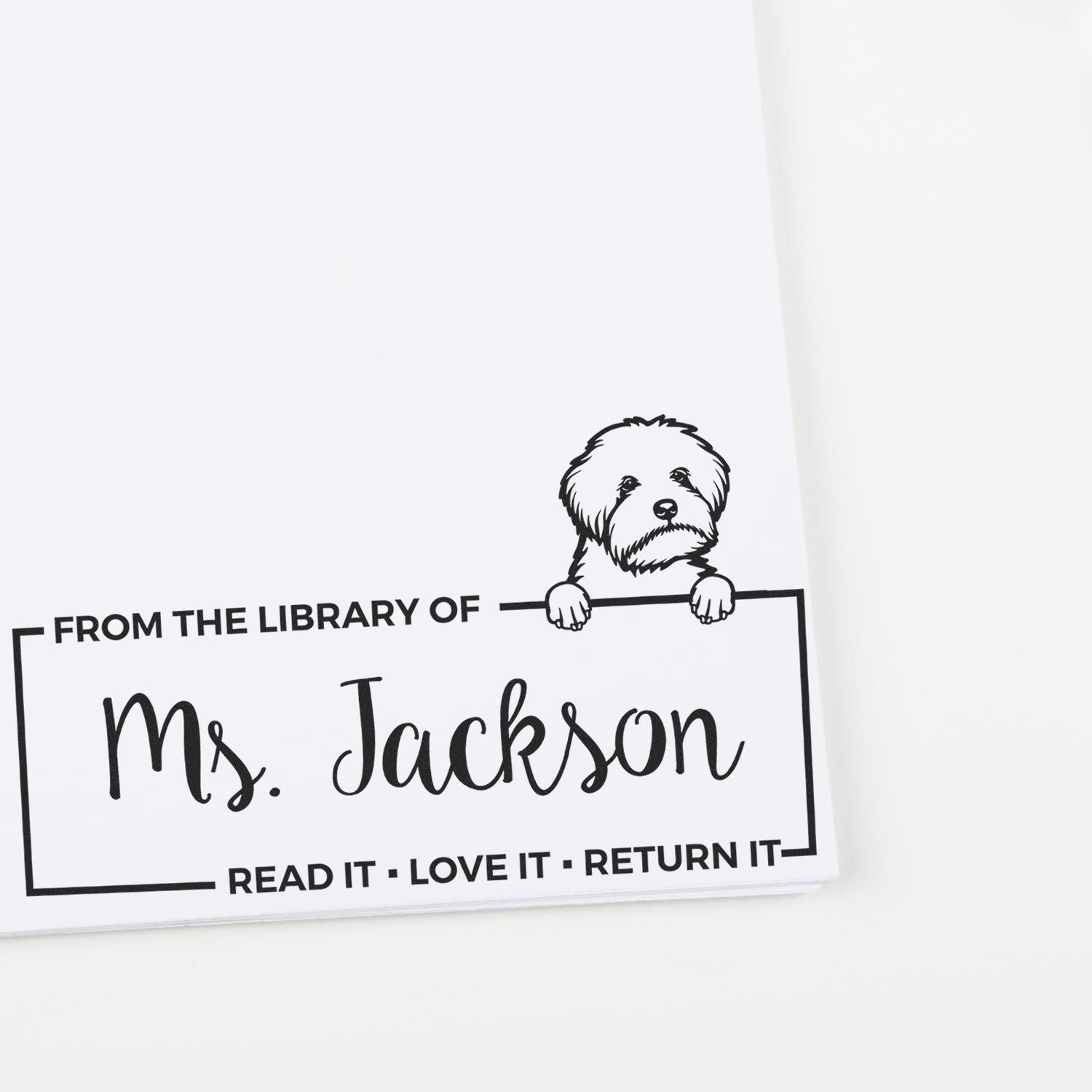 Personalized library book stamp for Ms. Jackson with dog illustration and Read it, Love it, Return it message.