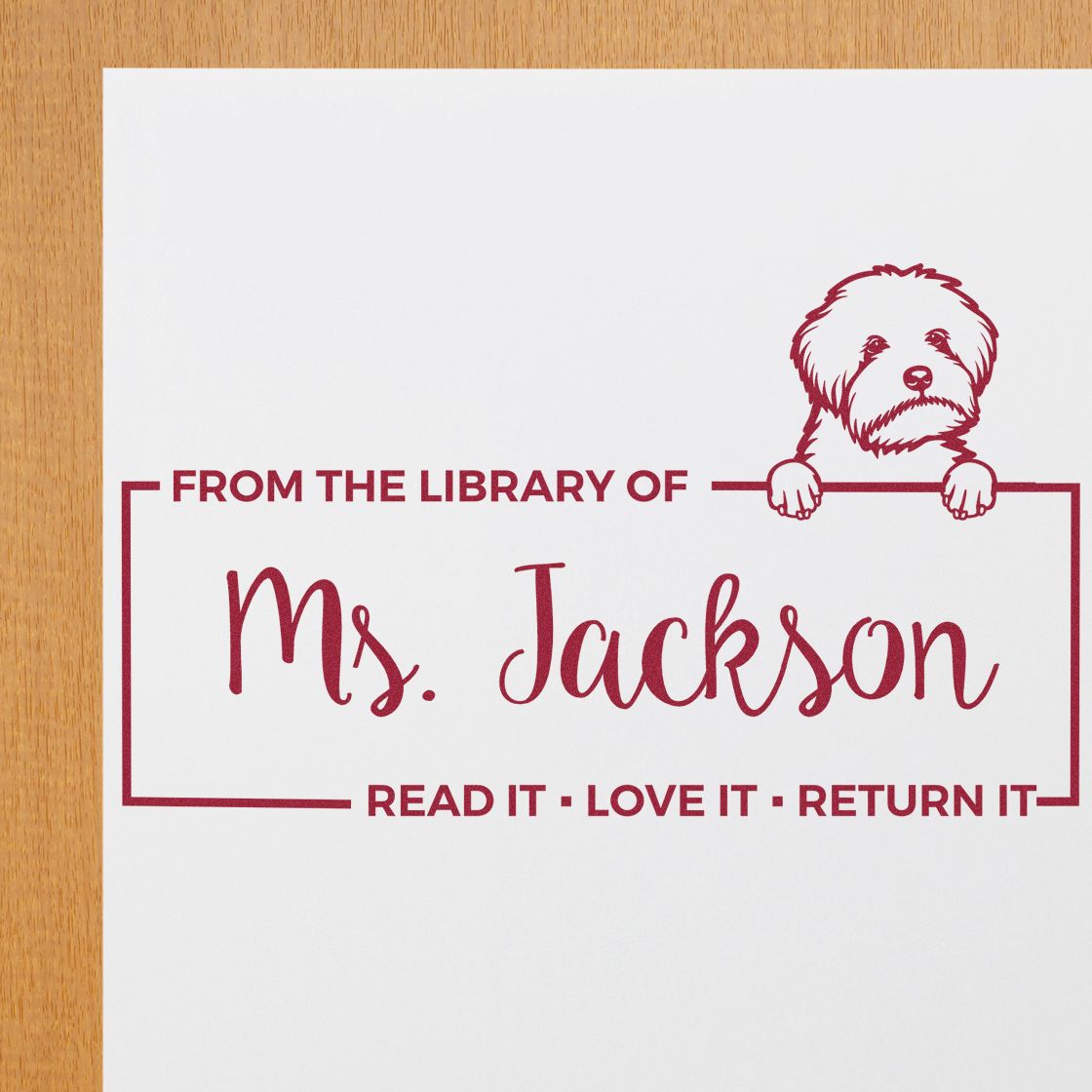 Custom library rubber stamp with dog illustration, From the library of Ms. Jackson, and Read it, love it, return it message.