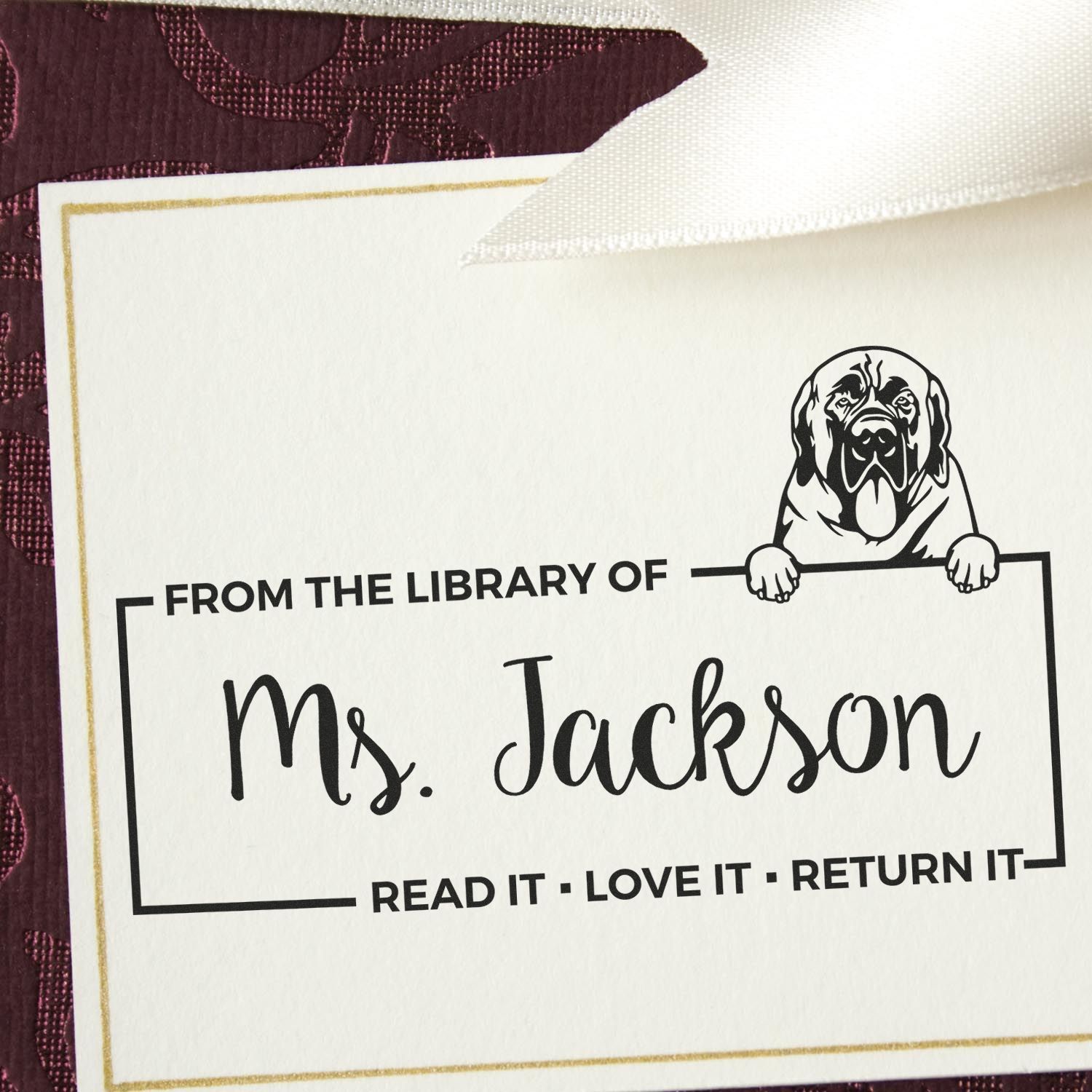 Personalized library rubber stamp for Ms. Jackson with dog illustration and Read It, Love It, Return It book return message.