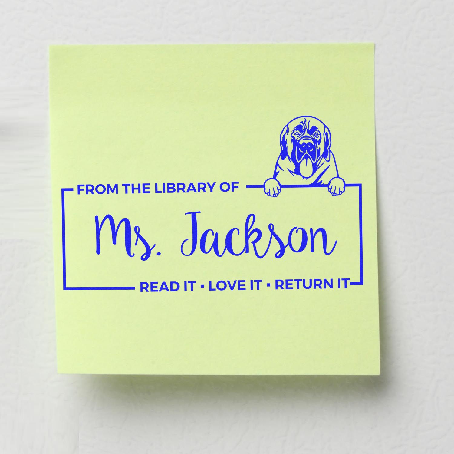 Personalized library rubber stamp for Ms. Jackson with dog graphic and Read it, love it, return it bookplate text.